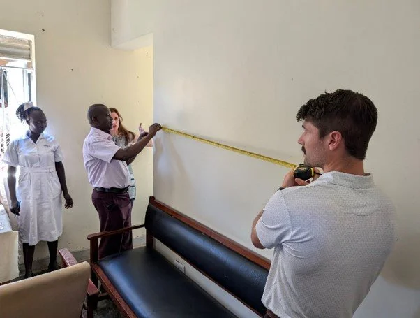 Measuring space for new shelving at Soroti Regional Hospital chronic disease pharmacy area 