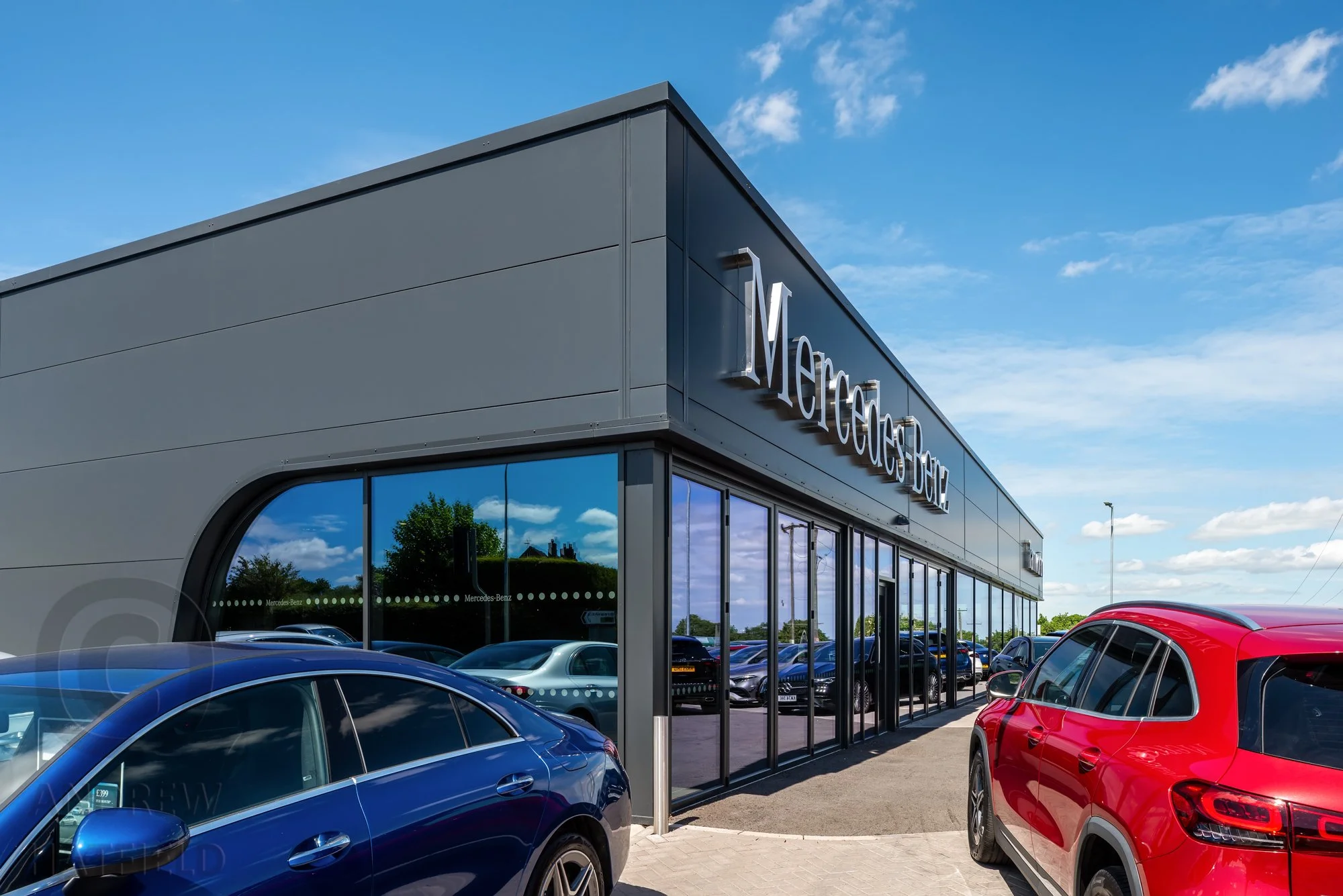 South west corner of the showroom at Mercedes-Benz Tamworth showing curverd glazed opening deatil photographed by Andrew Hatfield Architectural Photographer