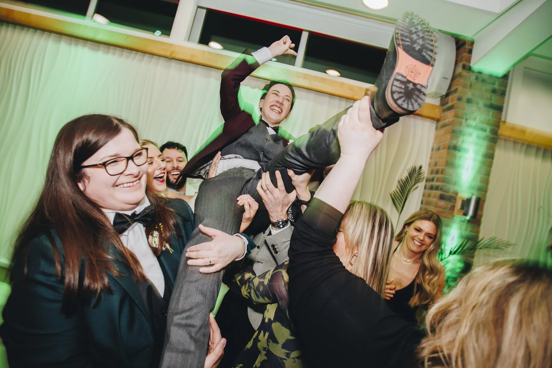 Candid group fun at a lively wedding reception