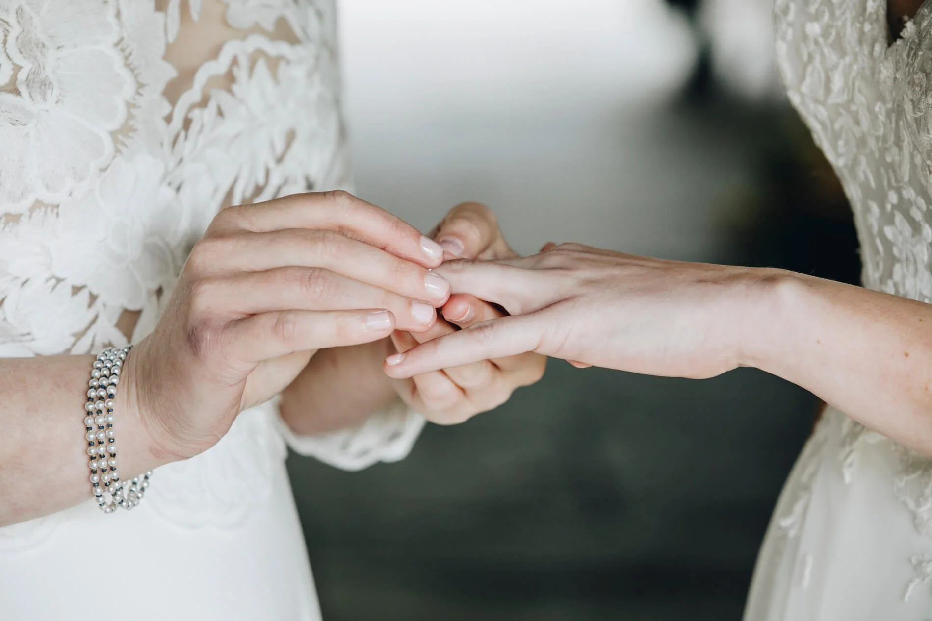 Two women exchanging wedding rings
