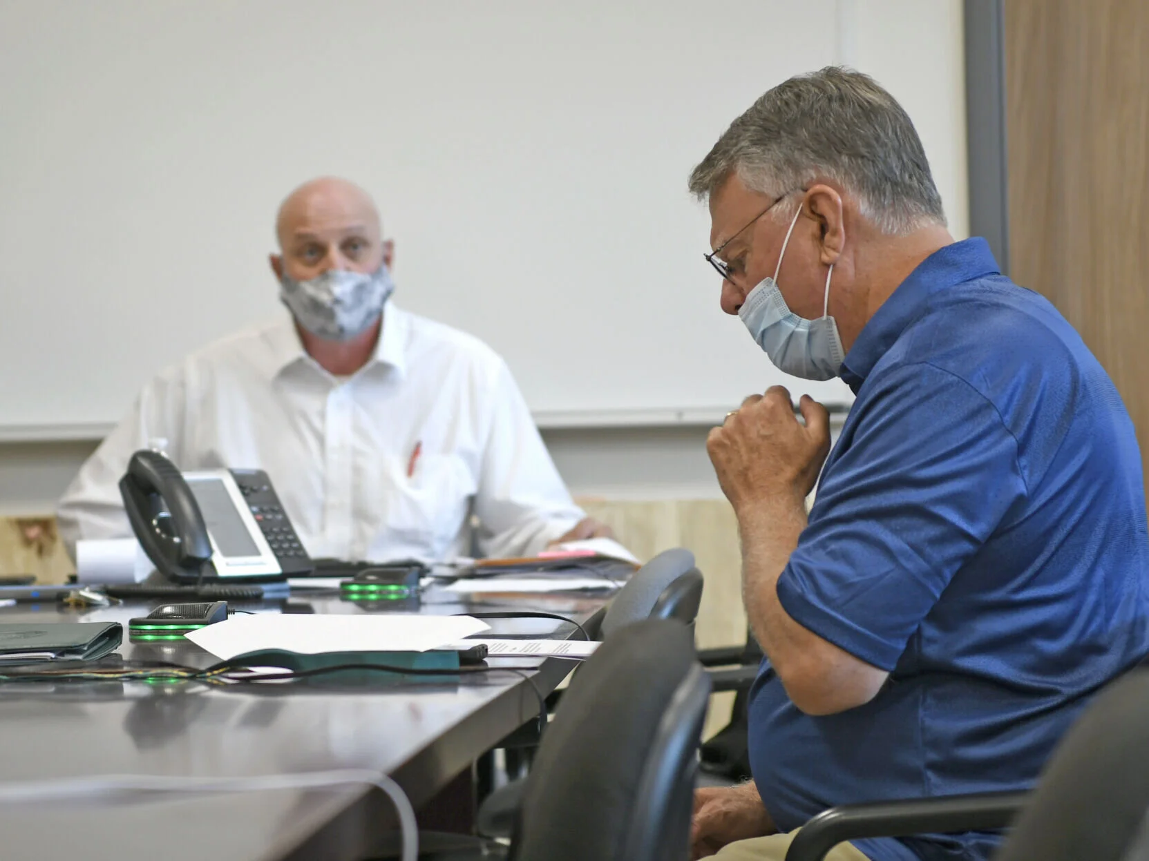 Mercer County Commission President Gene Buckner, right, addresses Dr. Randy Maxwell, the chairman of the Mercer County Board of Health, during a meeting on Wednesday.