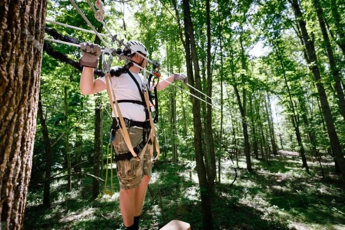 Preparing to go on a zipline through the beautiful woods.