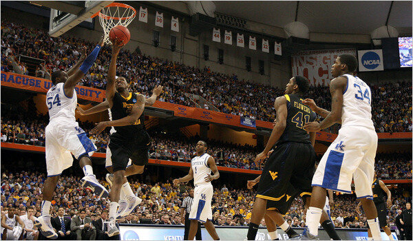 WVU forward Devin Ebanks drives for a layup against former Huntington High School star Patrick Patterson in the 2010 Elite 8 (Jim McIsaac/Getty Images)