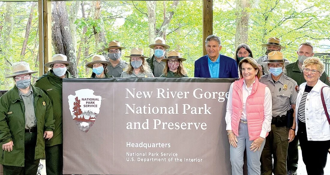 Photo by Steven Allen Adams U.S. Senators Joe Manchin and Shelley Moore Capito, and Appalachian Regional Commission Co-Chair Gayle Manchin join park rangers to celebrate the official naming of the New River Gorge National Park and Preserve.