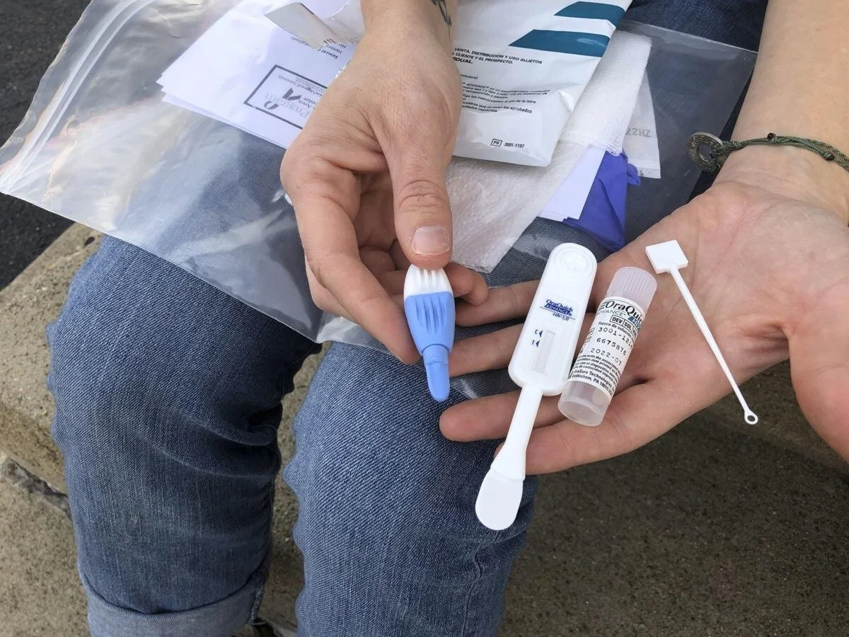 A Solutions Oriented Addiction Response organizer displays an HIV testing kit Tuesday, March 9, 2021, in Charleston (Via AP News)