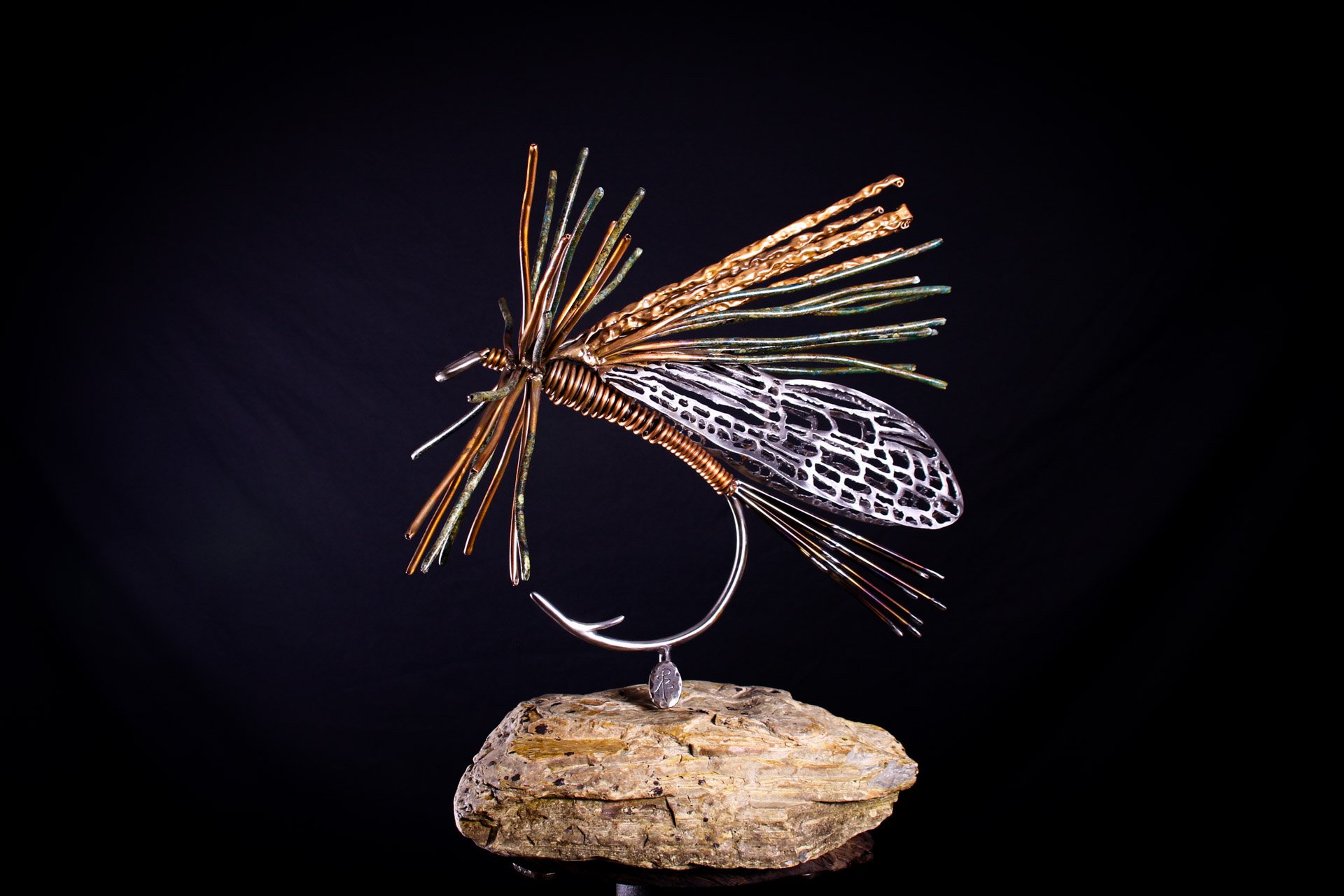 The Stonefly, a luxury handcrafted metal sculpture designed for discerning art collectors. Composed of meticulously detailed metals and refined detailing, this heirloom-quality piece captures the elegance of classic fly patterns. 