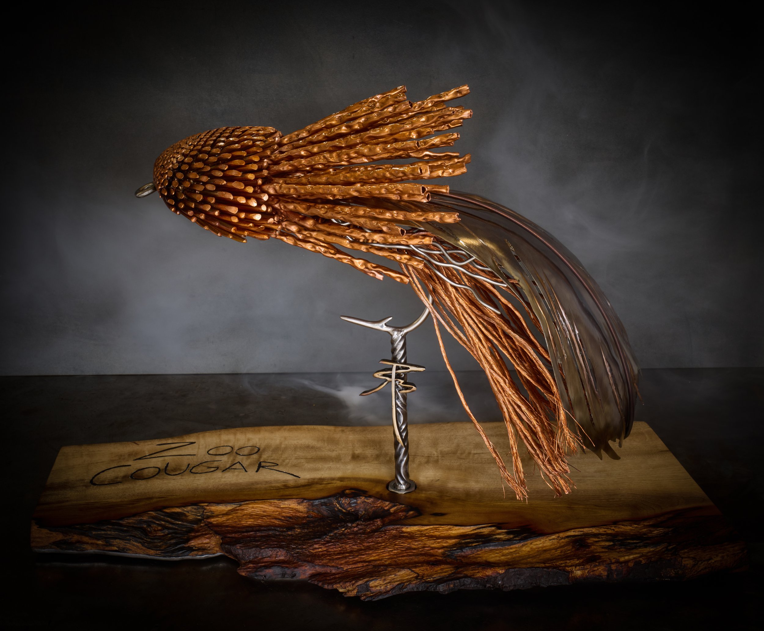 The Zoo Cougar, a luxury handcrafted metal sculpture designed for discerning art collectors. Composed of meticulously detailed metals and refined detailing, this heirloom-quality piece captures the elegance of classic fly patterns. 