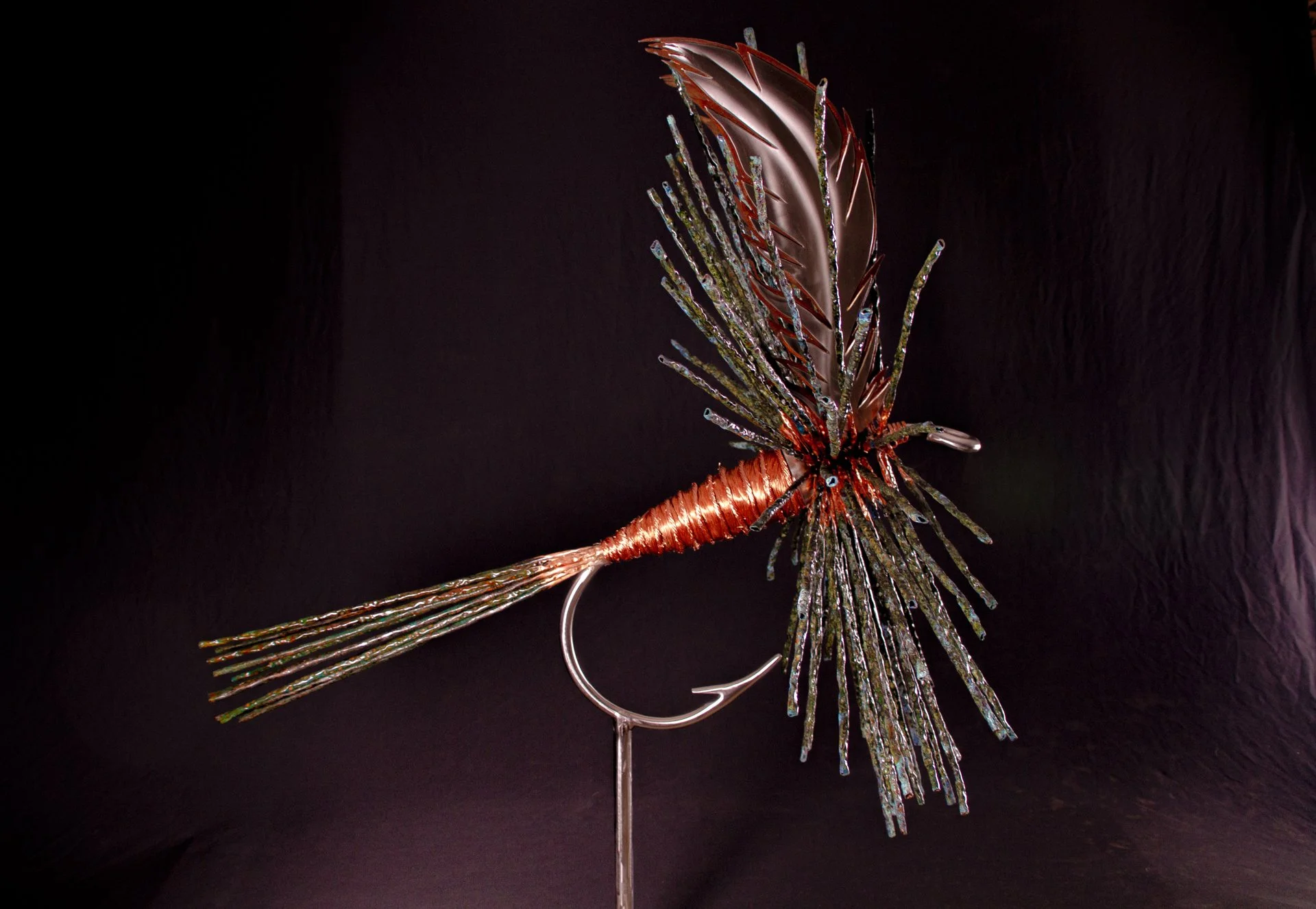 The Adam's Fly, A luxury handcrafted metal sculpture designed for discerning art collectors. Composed of meticulously detailed metals and refined detailing, this heirloom-quality piece captures the elegance of classic fly patterns. 