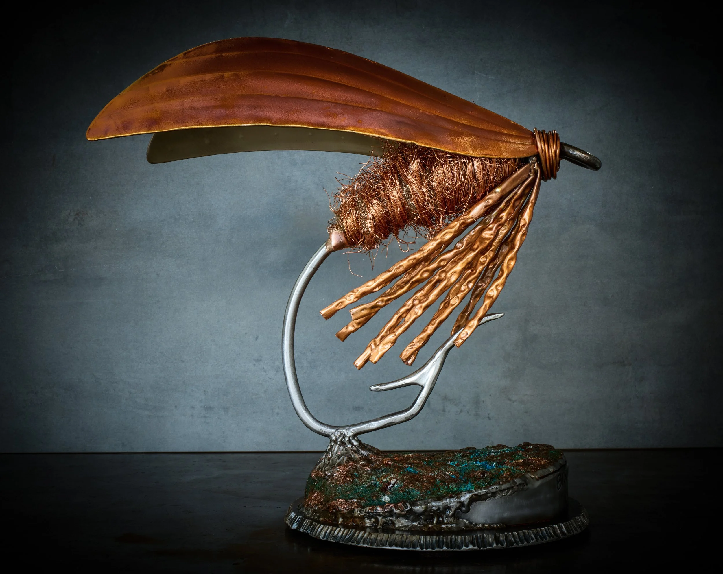 The Cow Dung is a traditional wet fly that has been used for hundreds of years. This sculpture is a monument to honor the rich history and tradition of fly fishing.