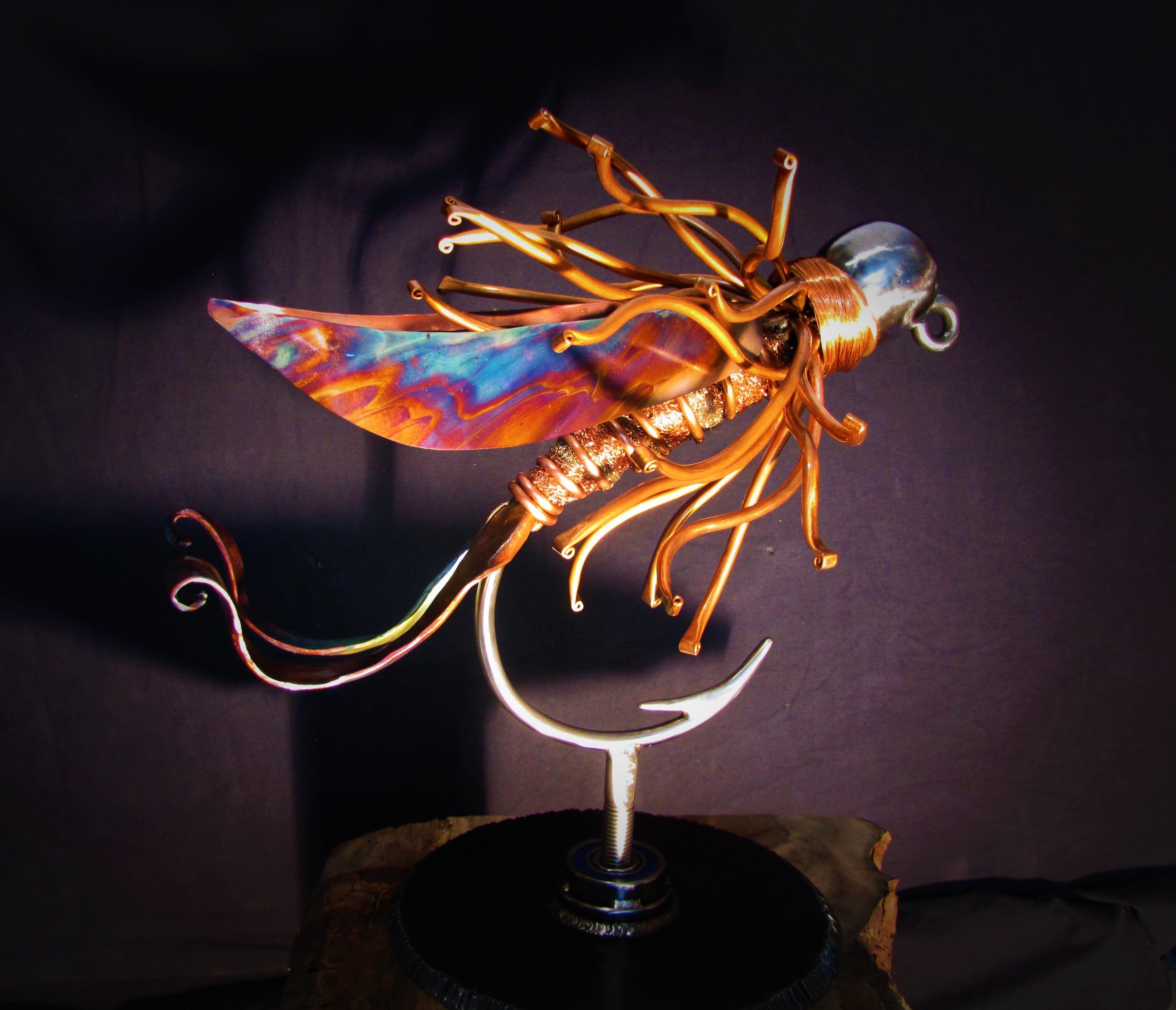 The Beadhead Nymph, a luxury handcrafted metal sculpture designed for discerning art collectors. Composed of meticulously detailed metals and refined detailing, this heirloom-quality piece captures the elegance of classic fly patterns. 