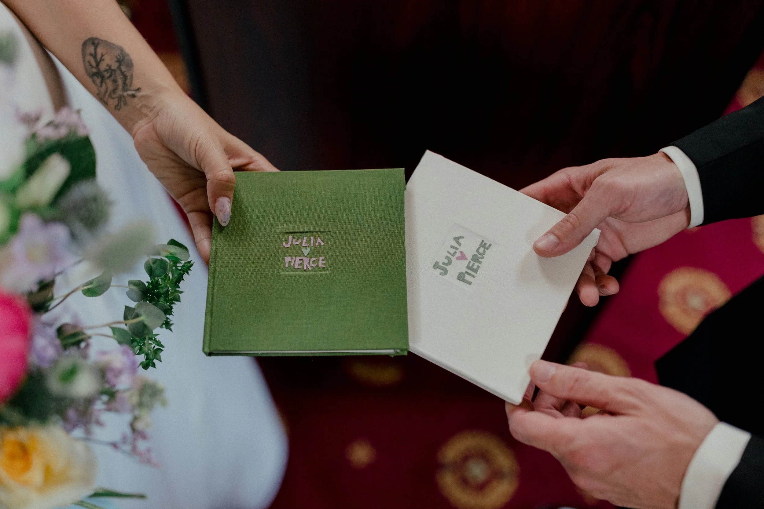 Hand-bound vow books made with cut paper and finished with a handmade stamp for a personal, intimate touch.