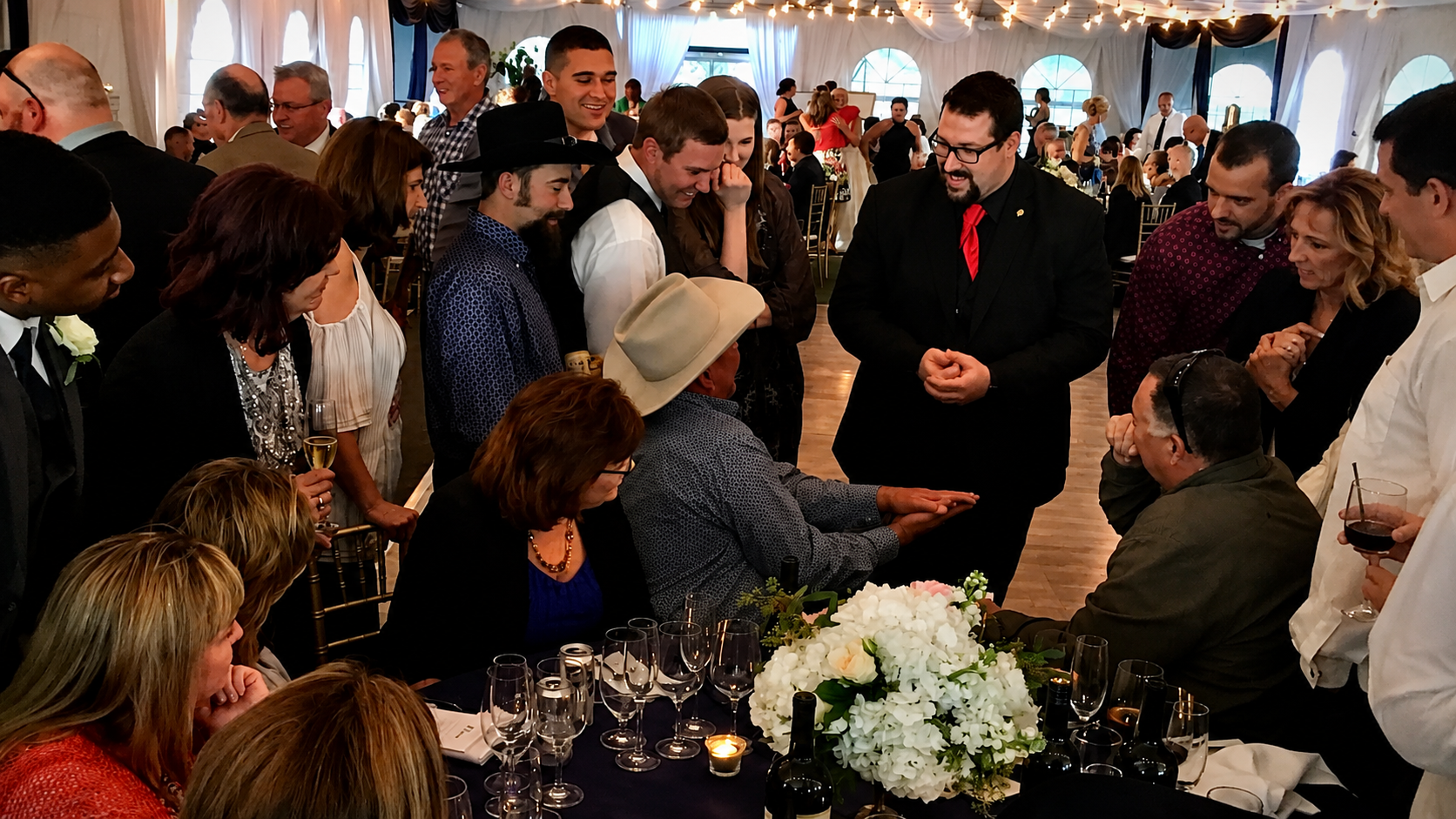Fresno magician Kyle Elder performing strolling close-up magic for guests at an event