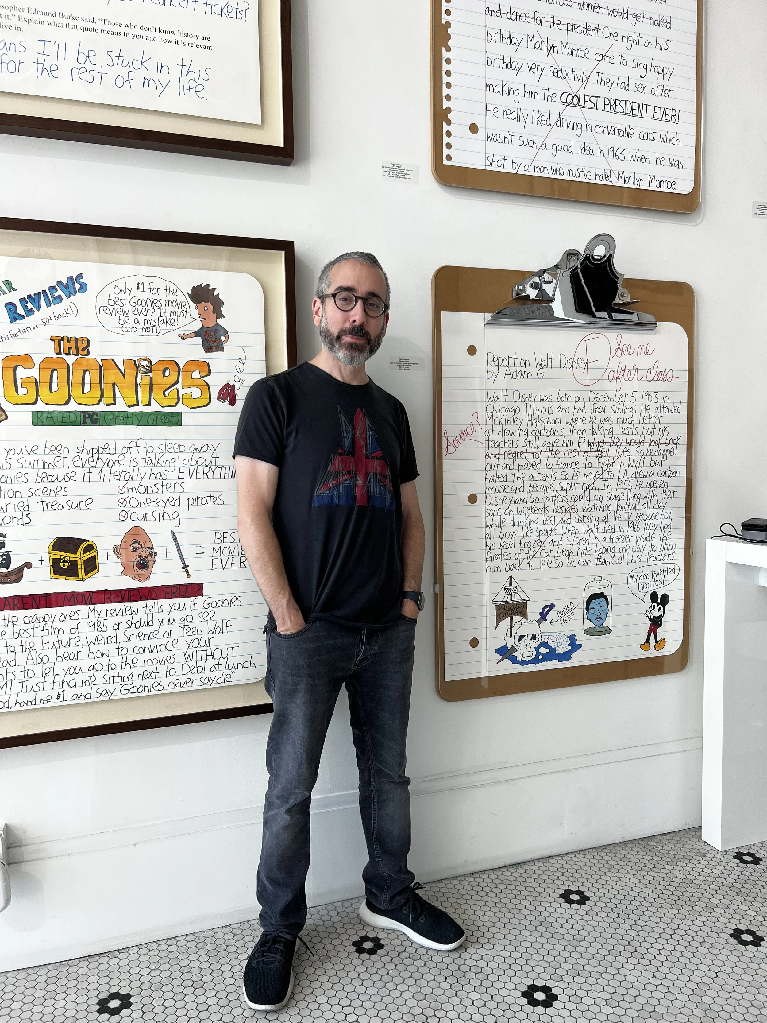 Adam Green standing next to custom clipboard and drawings.jpeg
