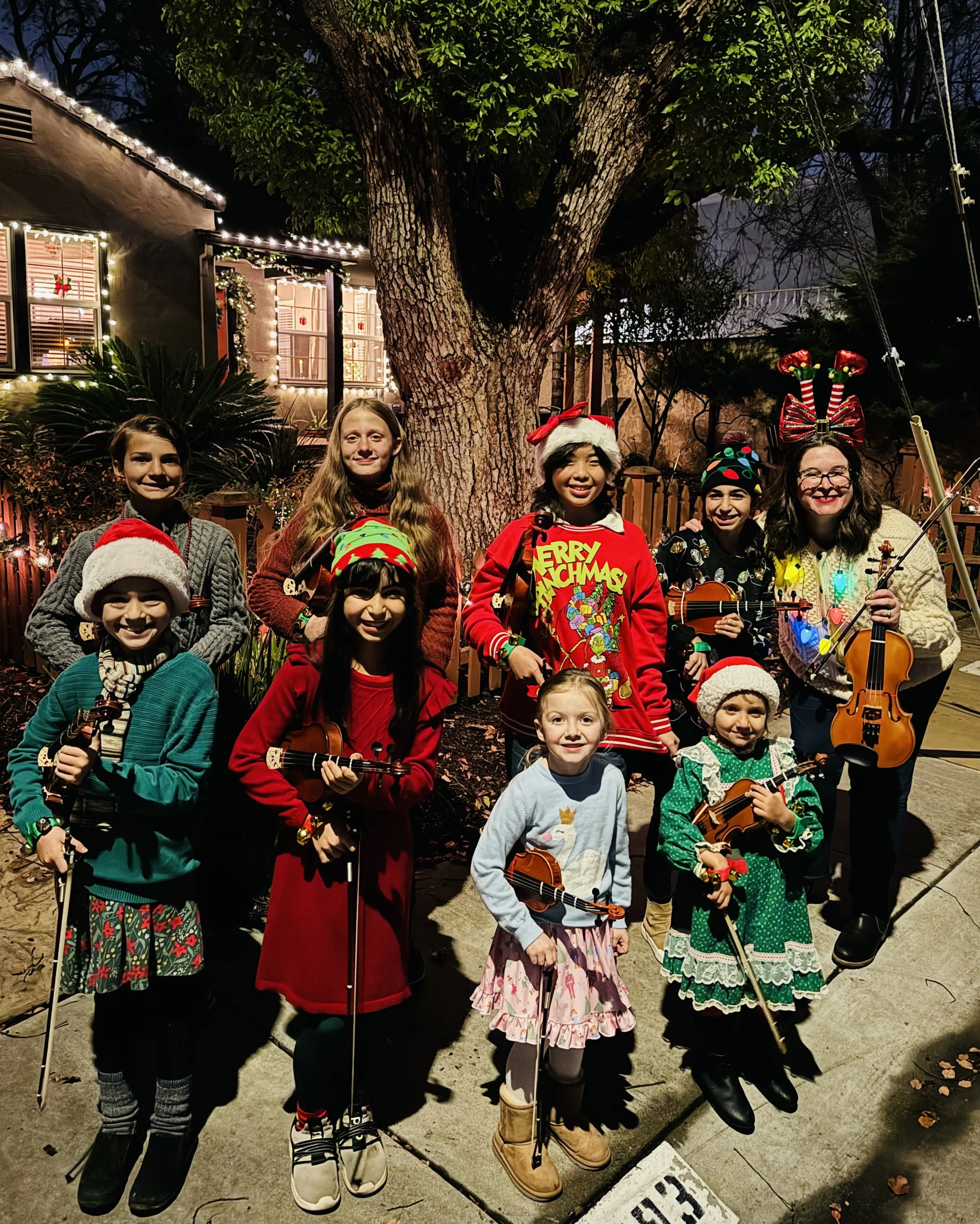 Gallagher Violins Suzuki Violin and Viola School Volumes 1, 2, 3, and 4 students after violin caroling through East Sacramento