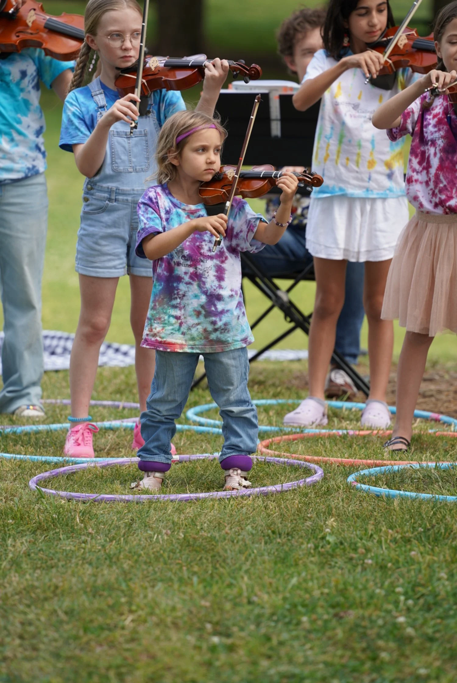 Gallagher Violins Suzuki Violin School Volume 1, 2, 3, and 4 students performing at East Portal Park in East Sacramento
