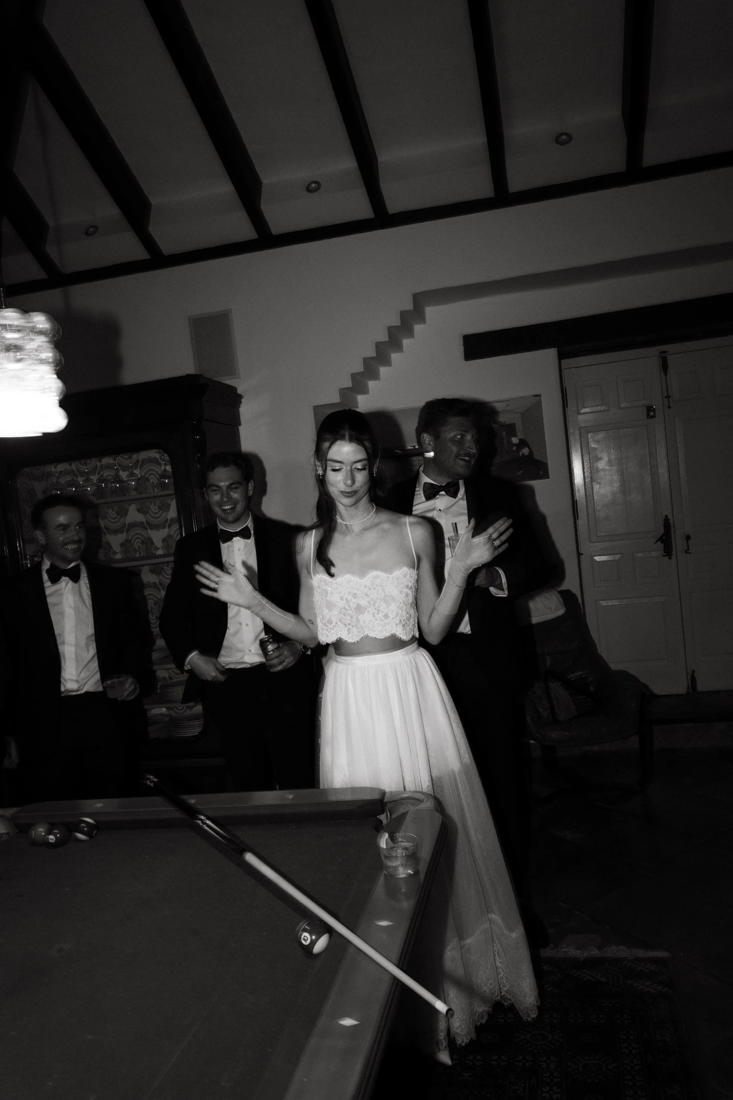 Documentary wedding photographer Málaga capturing guests during a pool game