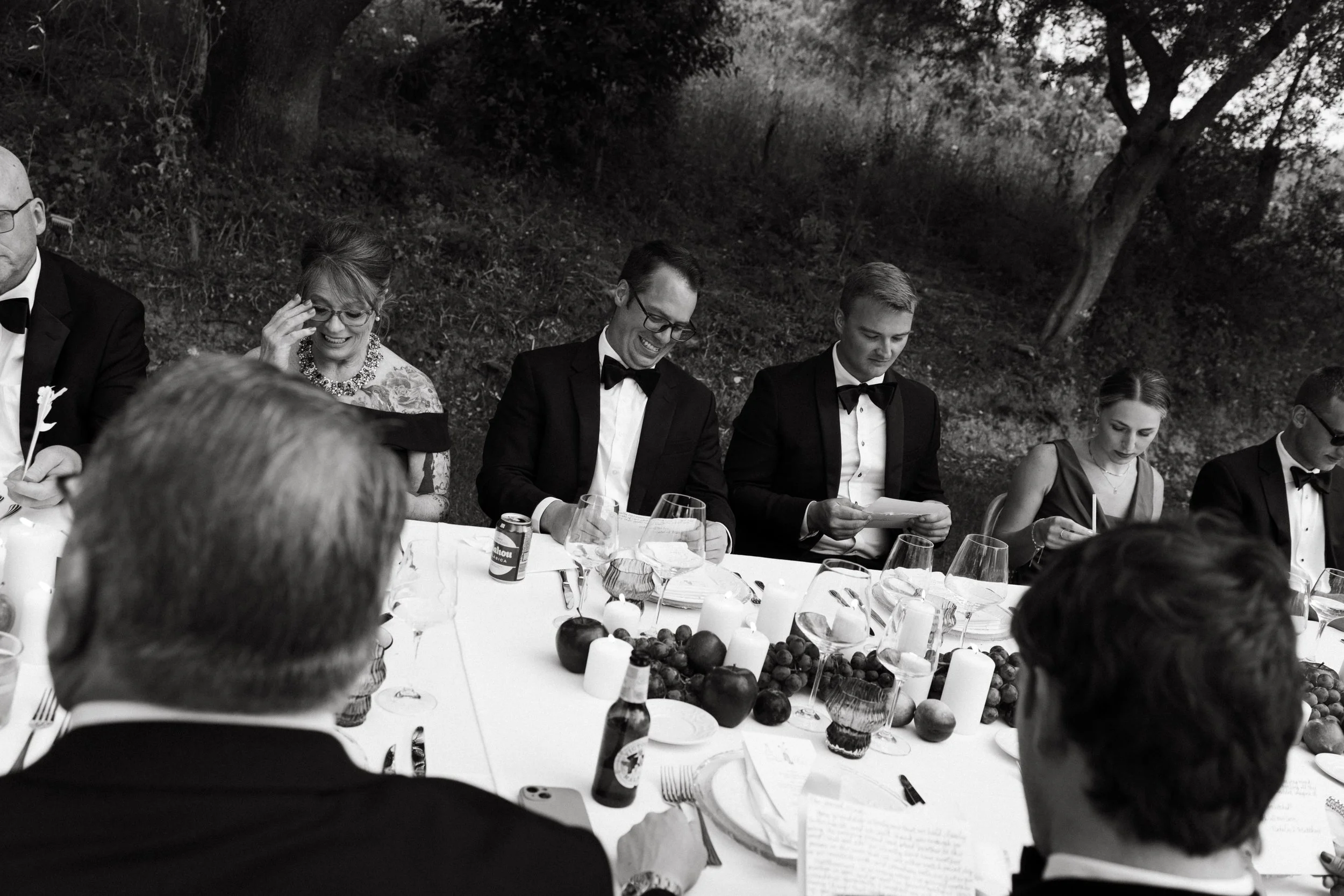 Guests reading handwritten letters during the wedding dinner