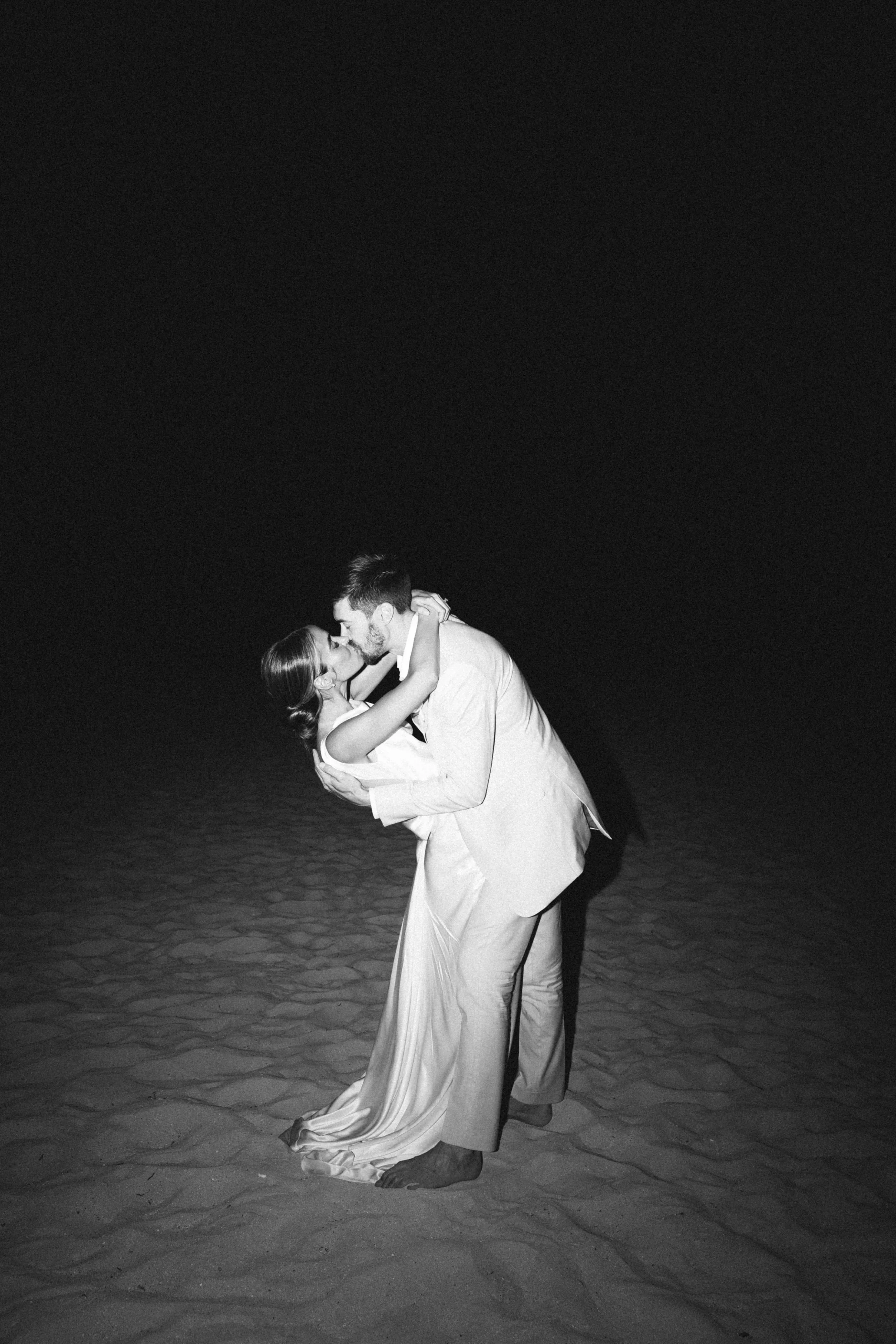Editorial wedding film photographer captures a couple in the sunset on the beach on film