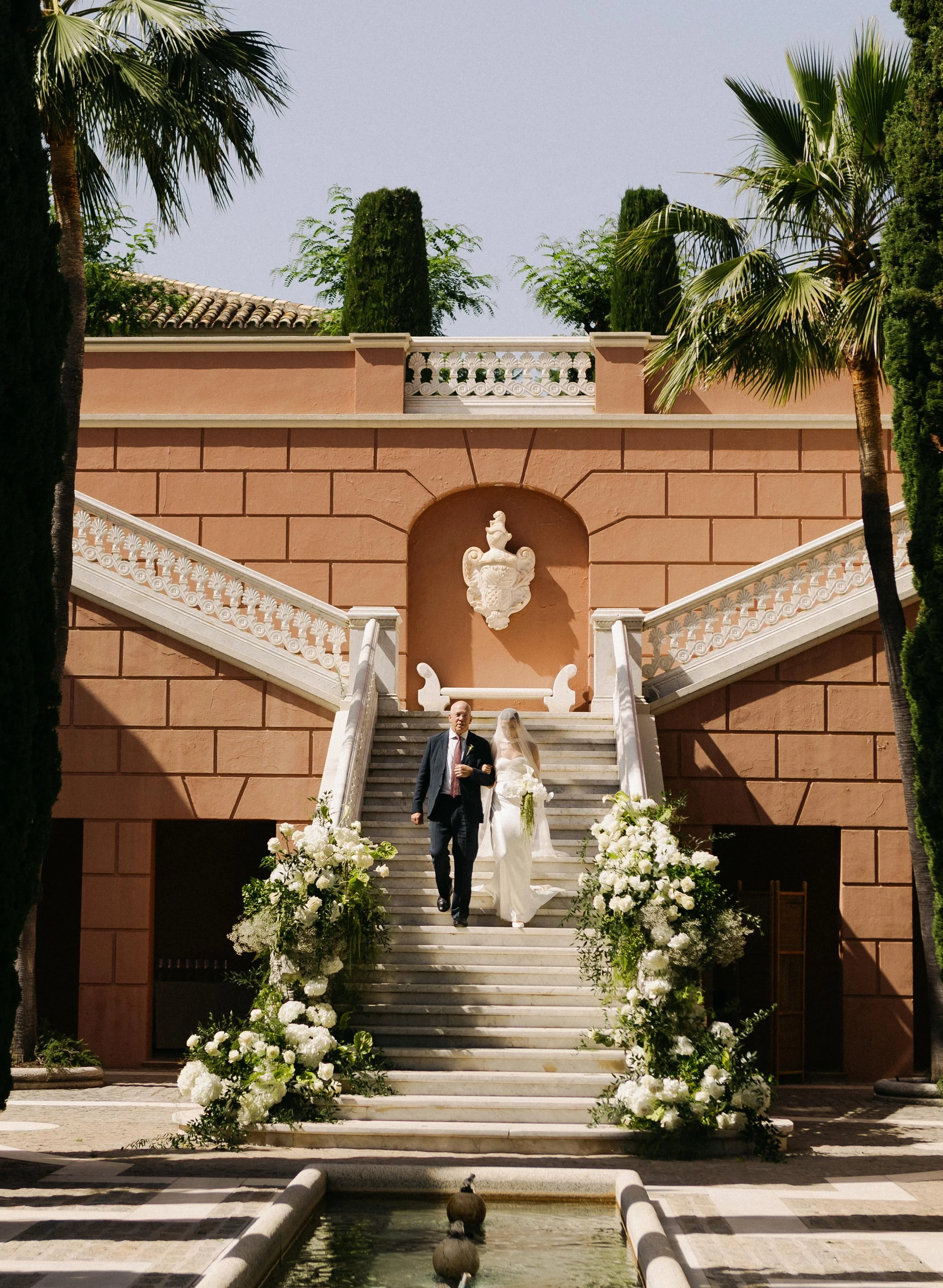 Bride walking down the staircase Marbella destination wedding Spain