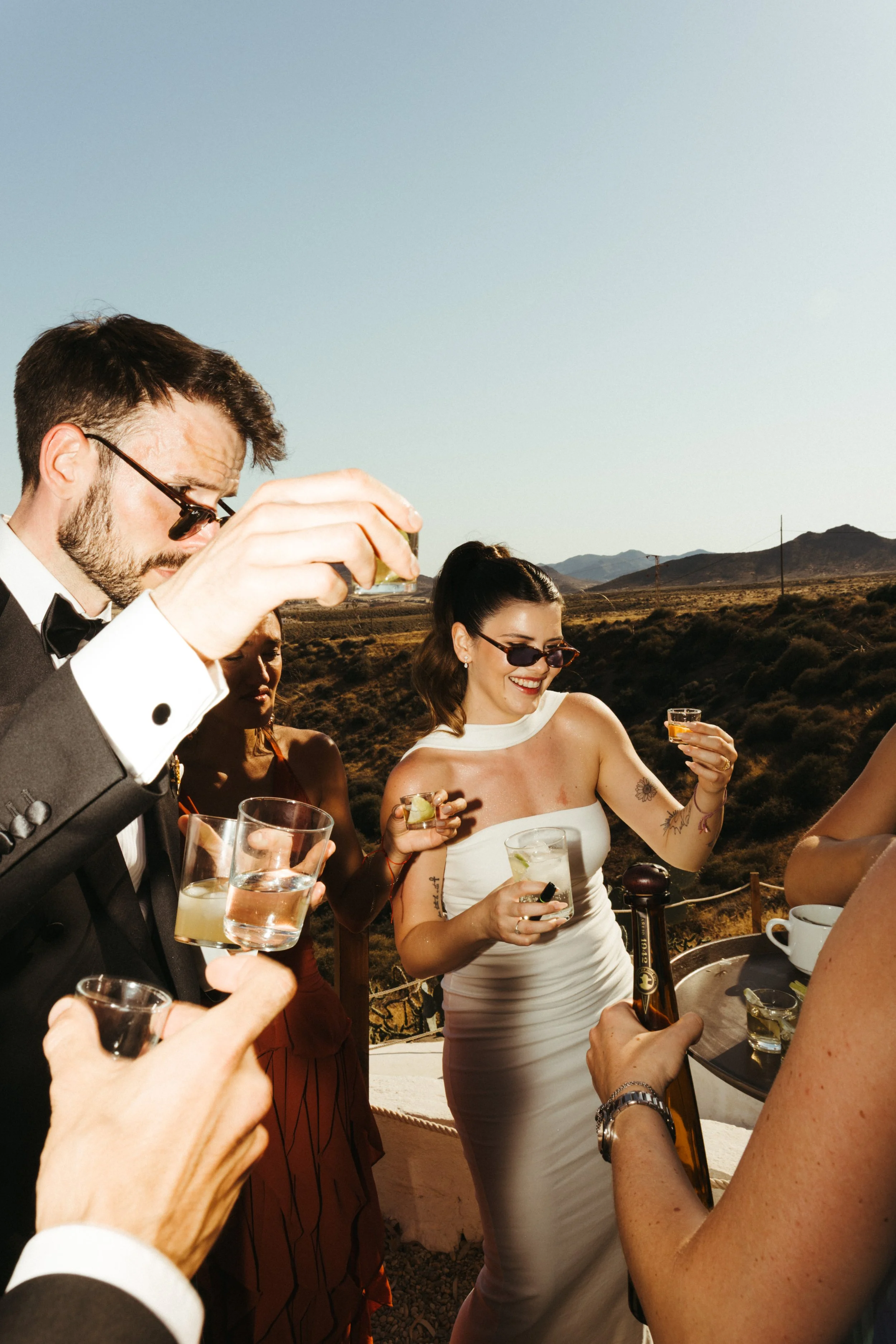 Destination wedding party beneath the setting sun