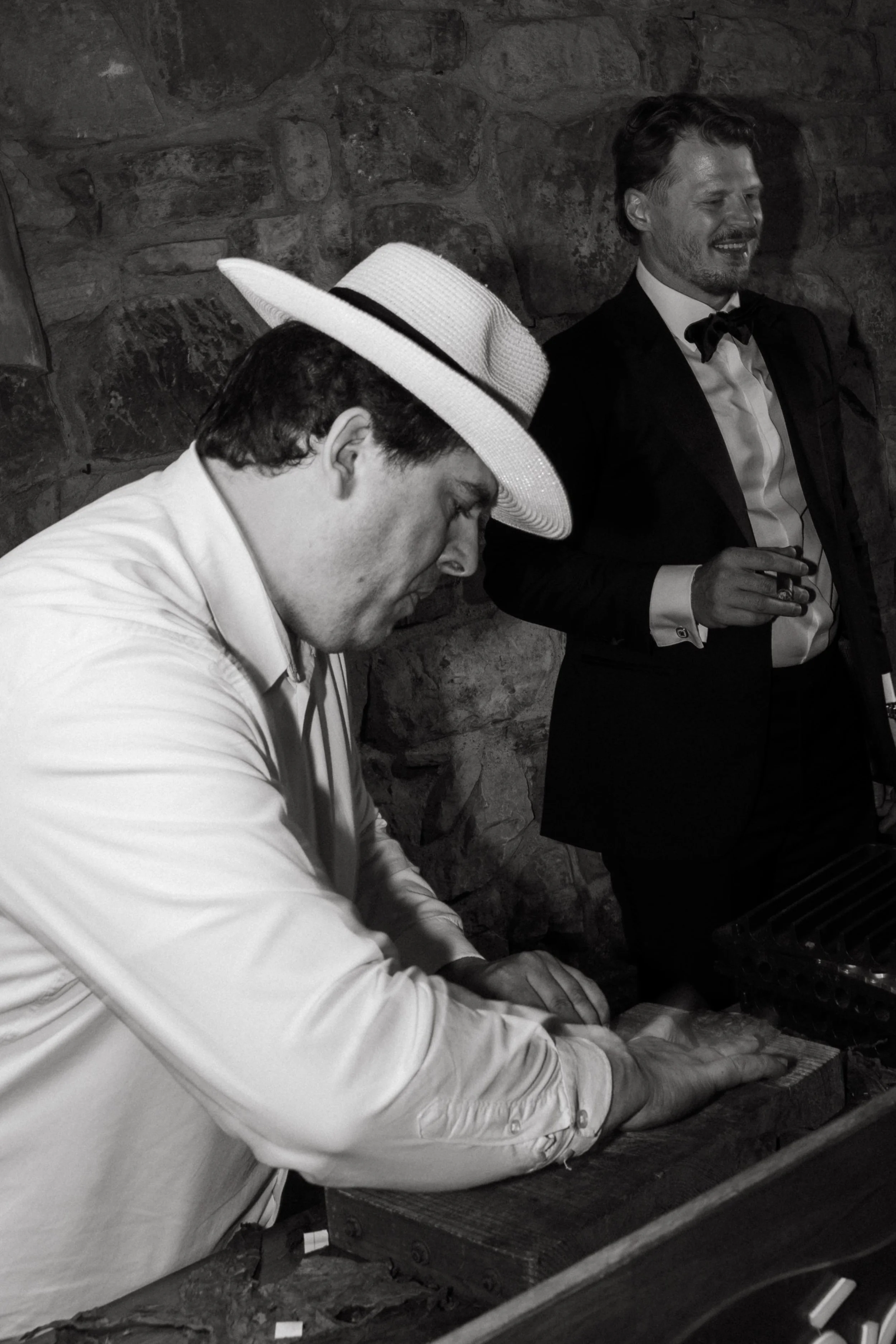 Documentary wedding photography capturing a cigar roller experience during the celebration