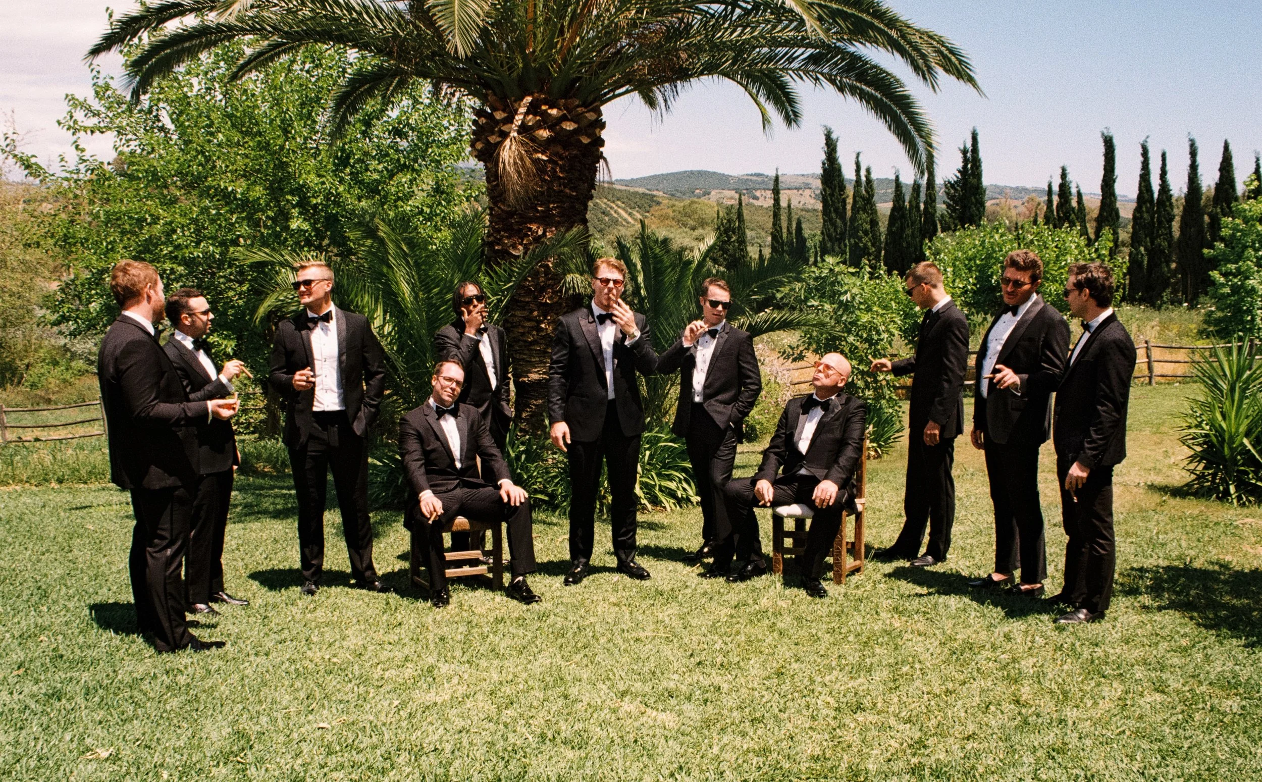 Groom getting ready with friends before a luxury destination wedding