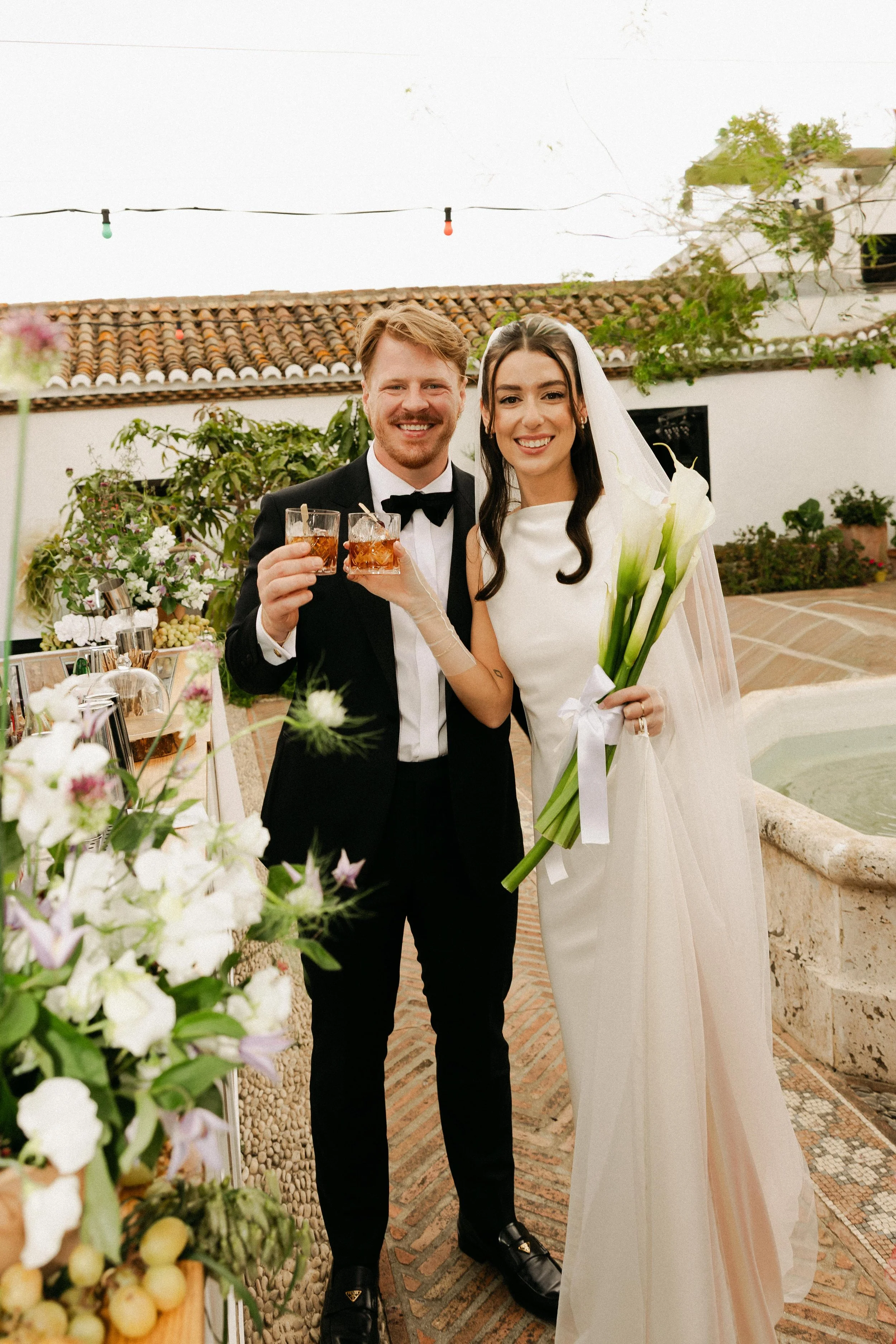 Wedding couple enjoying signature cocktails after the ceremony captured by Spain wedding film photographer