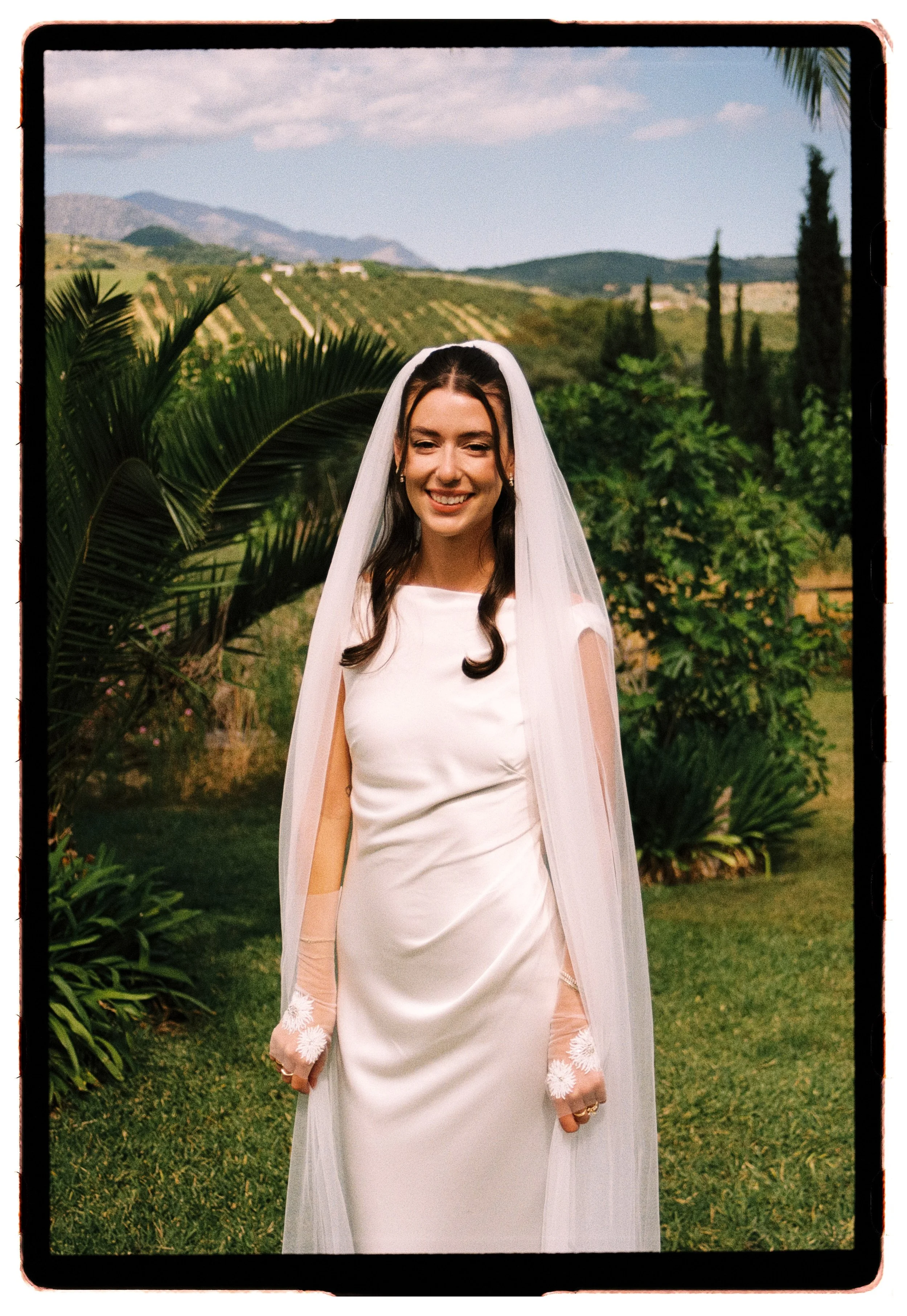 photographer captures a beautiful bride in a sunlit garden in film