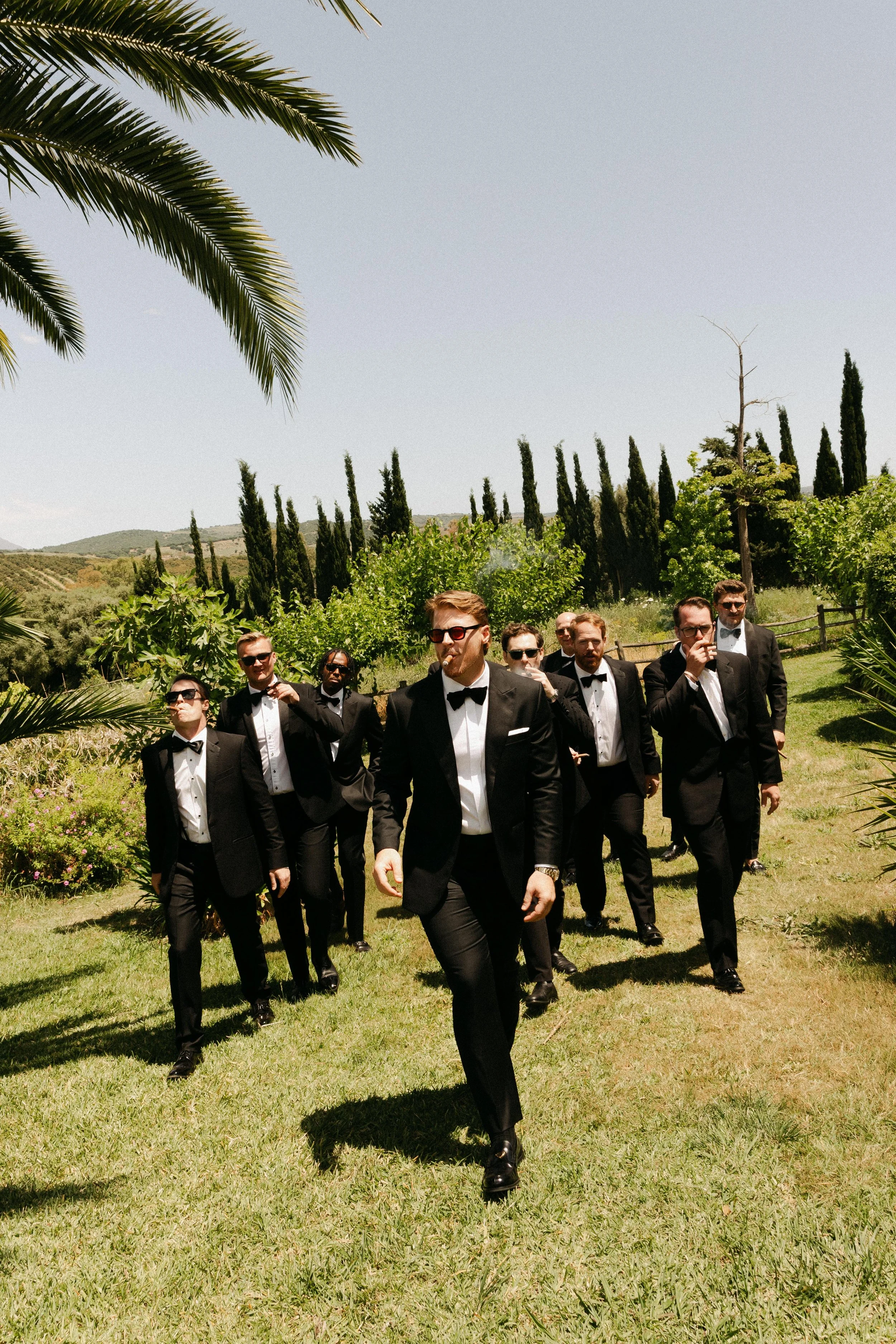 Groomsmen enjoying cigars before the wedding ceremony