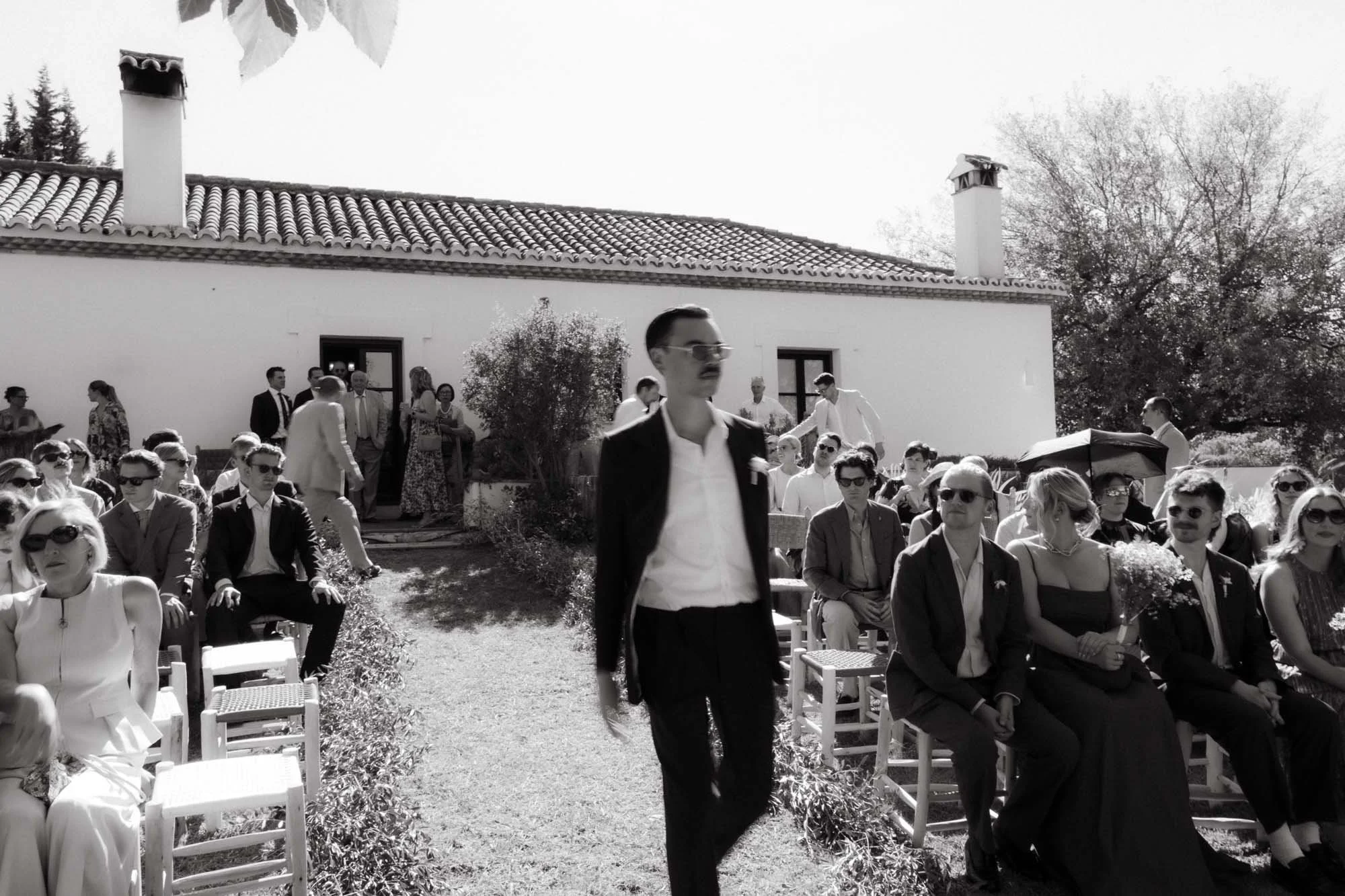 Groom walking down the aisle during an emotional destination wedding ceremony in Spain