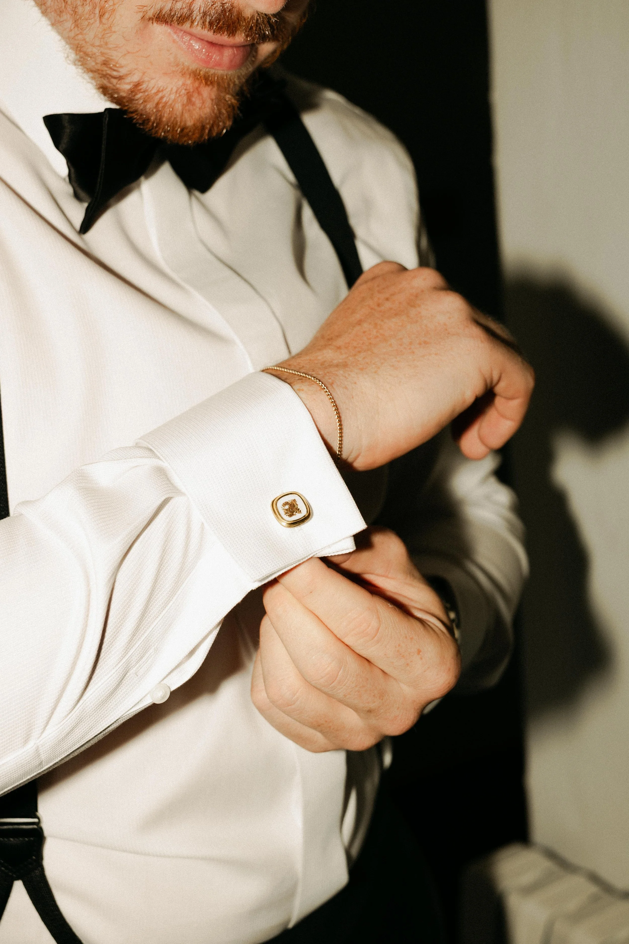 Groom getting ready with friends before a luxury destination wedding