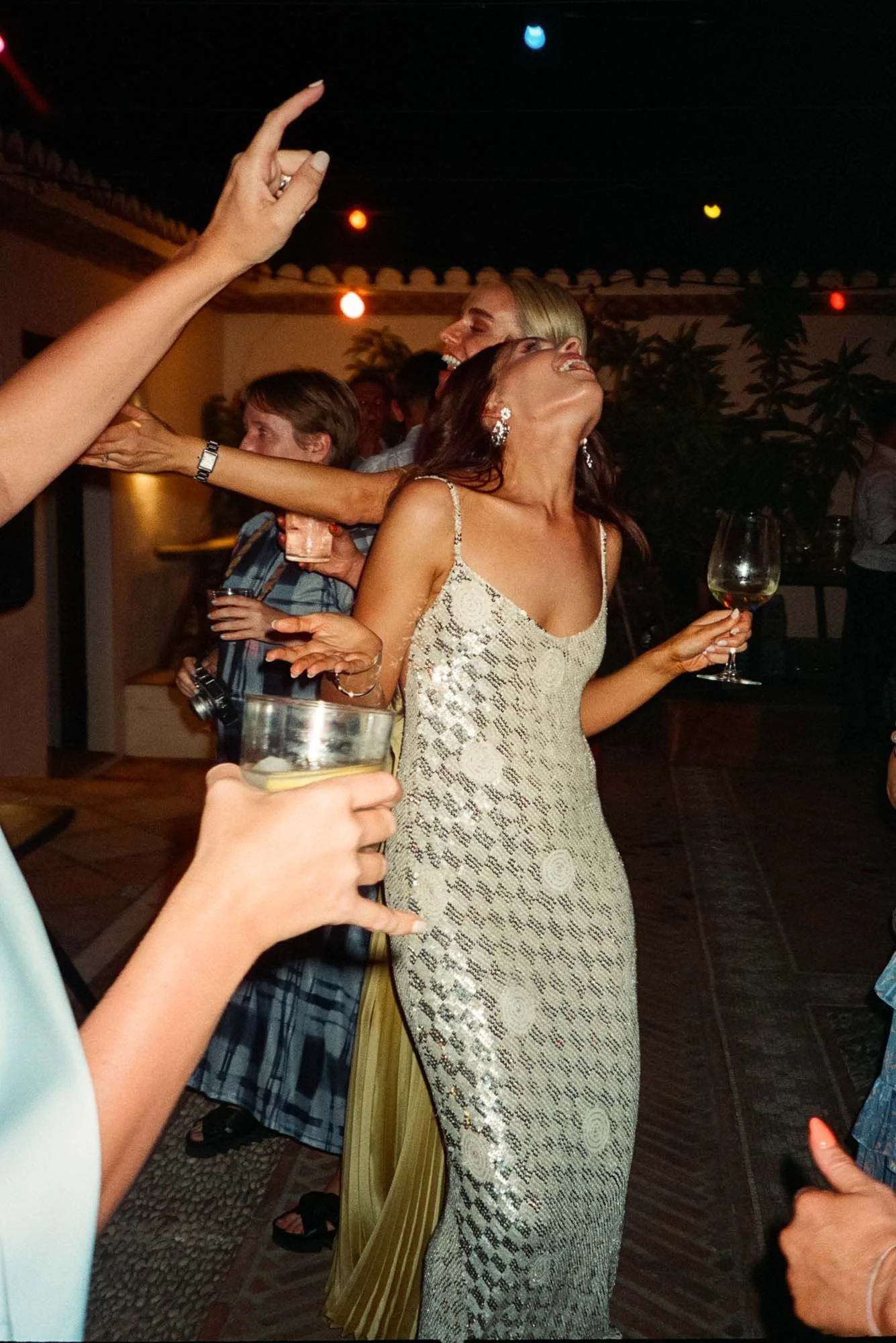 Bride dancing during a destination wedding night in Spain full of joy and spontaneity photographed on film
