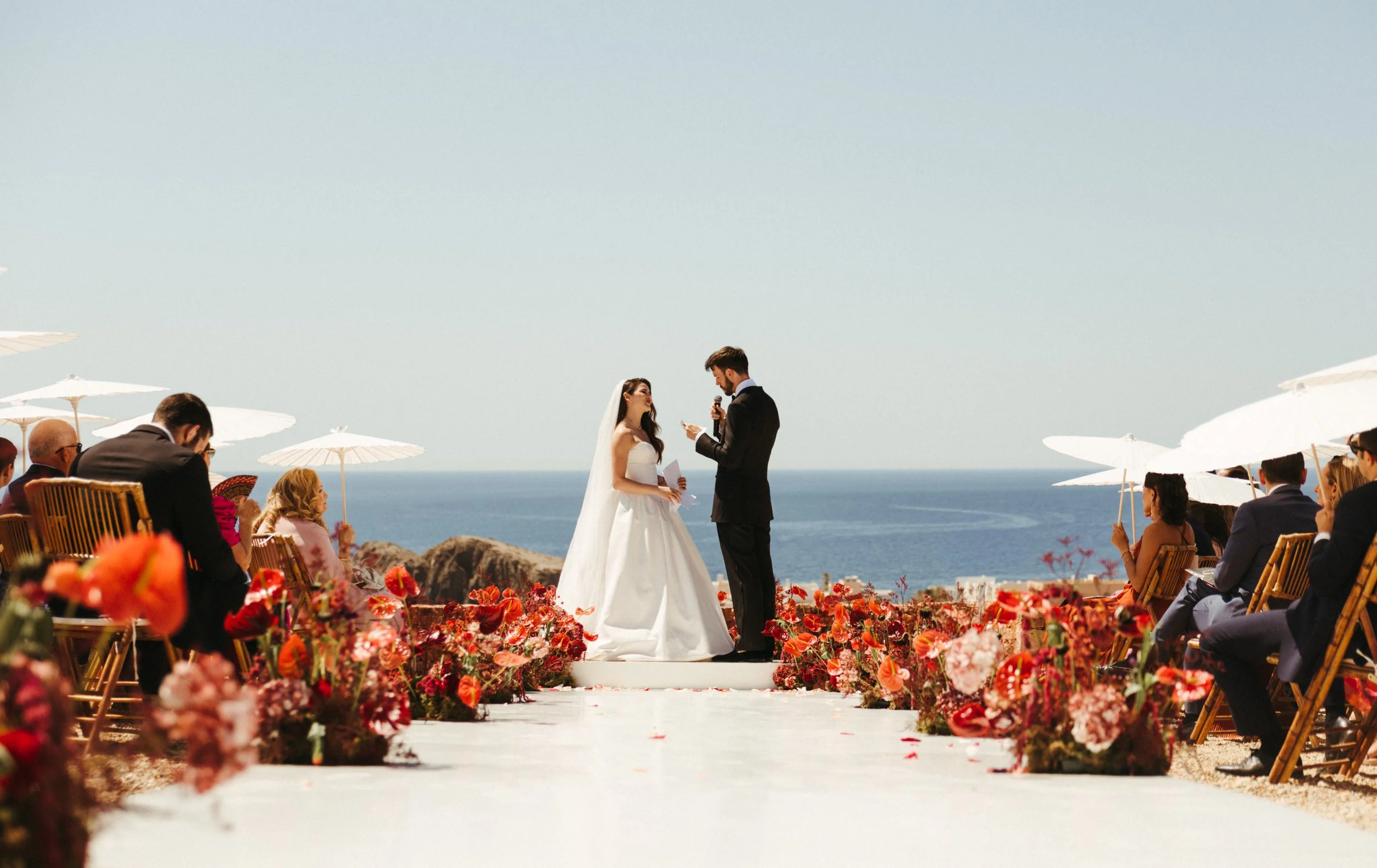 Design-led wedding ceremony surrounded by dramatic florals