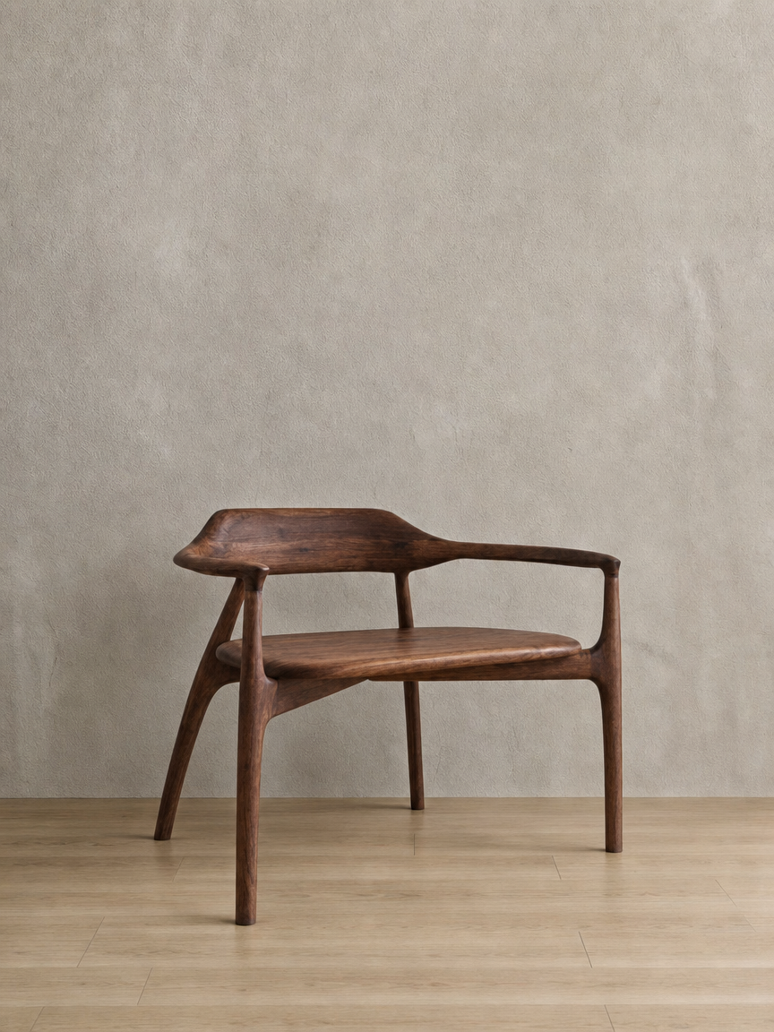 Wooden bench with armrests and a backrest, set against a plain beige wall on a wooden floor.