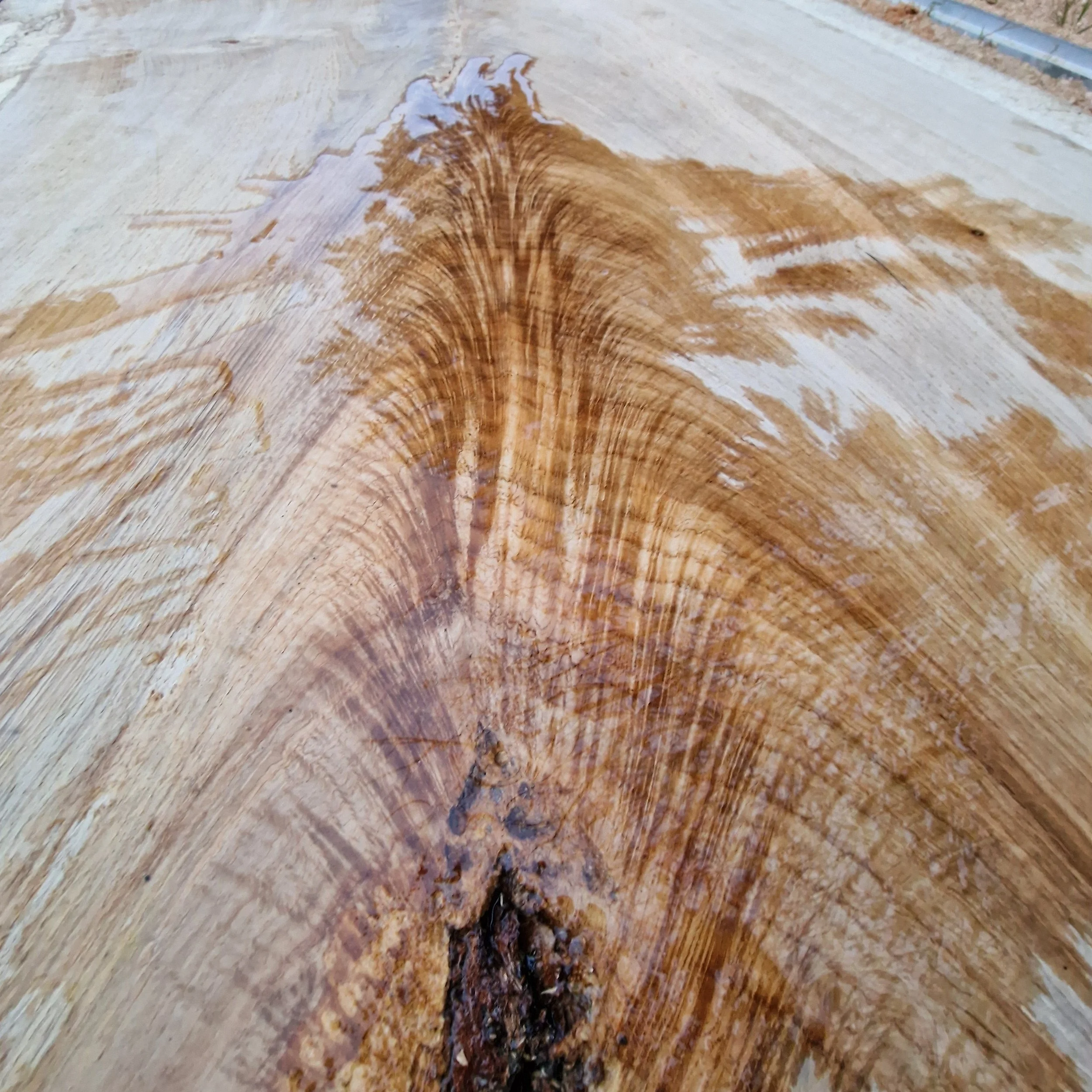 Close-up of a wooden surface with wood grain and a knot.