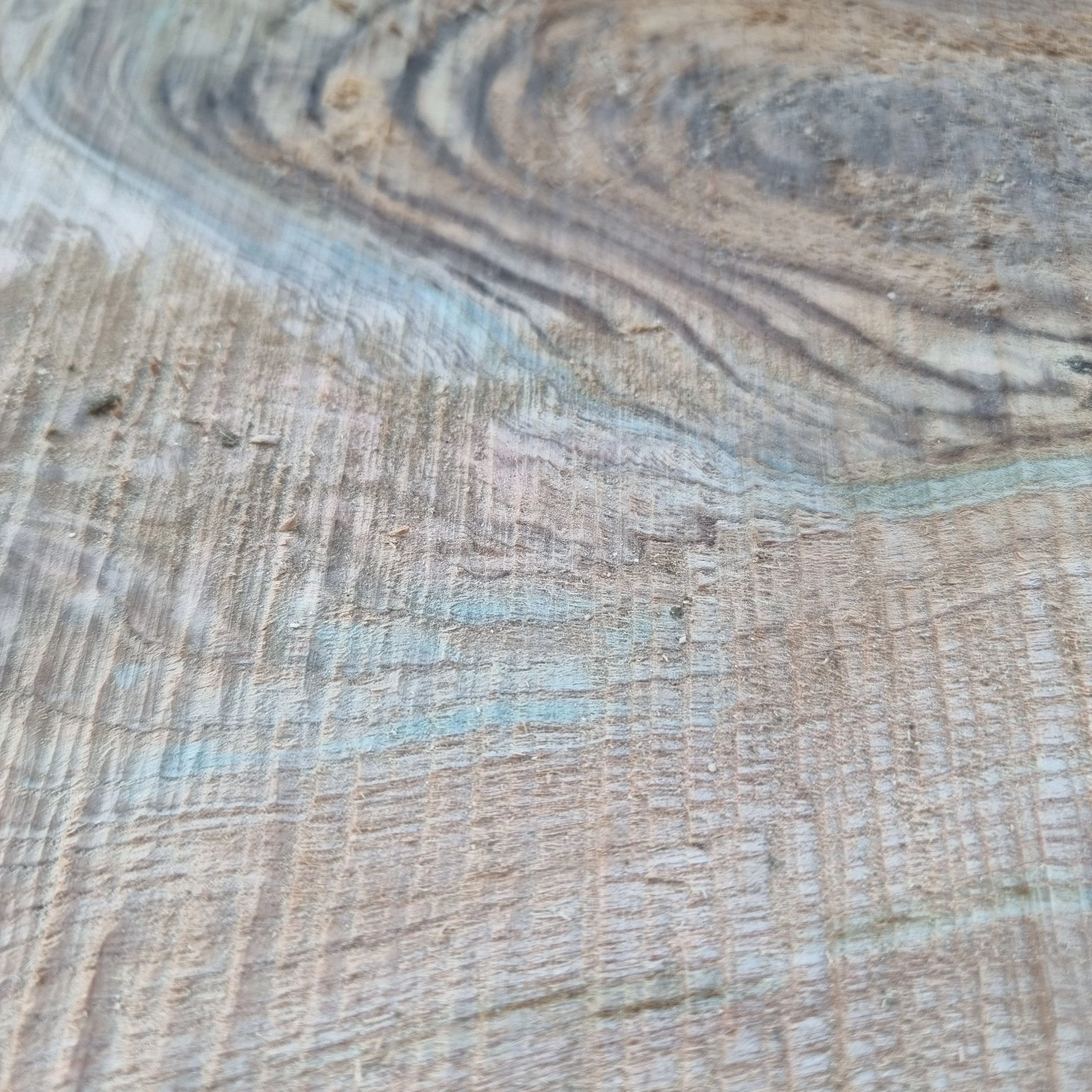 Close-up of weathered wood with visible grain and texture.