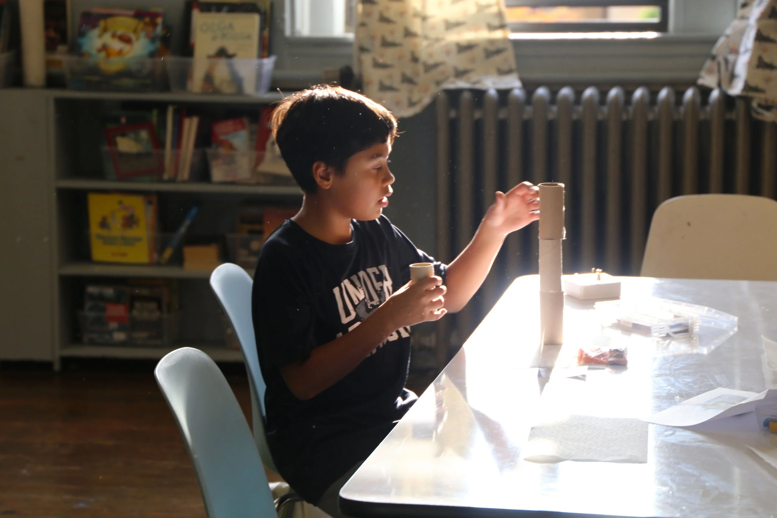 A Fusion student having fun while making a tower