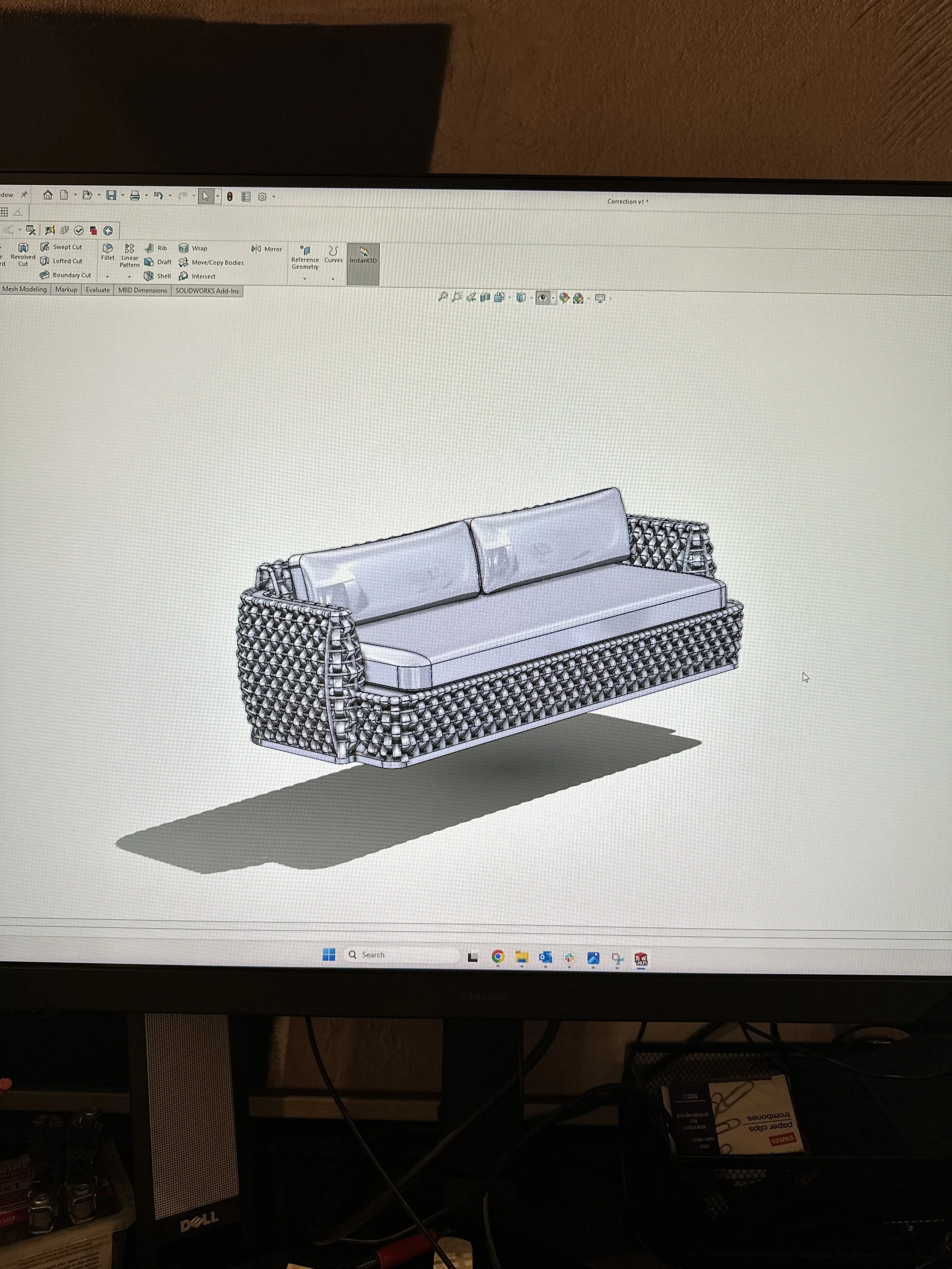 Complex outdoor fabric weave on a tubular metal sofa frame