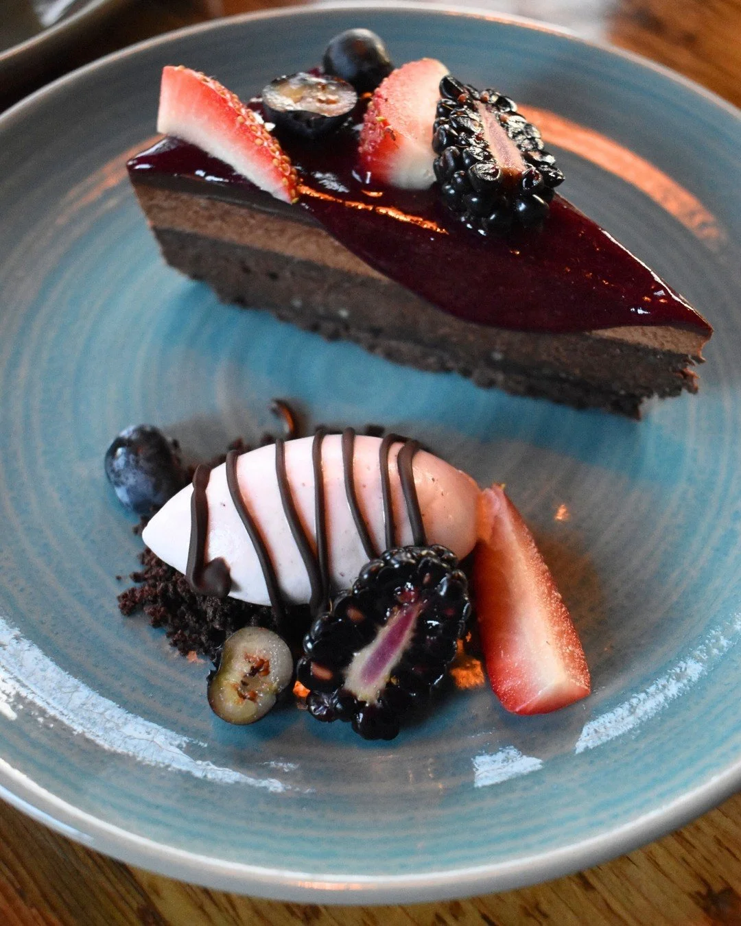 Decadence in every bite 🍫✨ Chocolate tart layered with raspberry ganache, caramel mousse, and wild berry sauce.