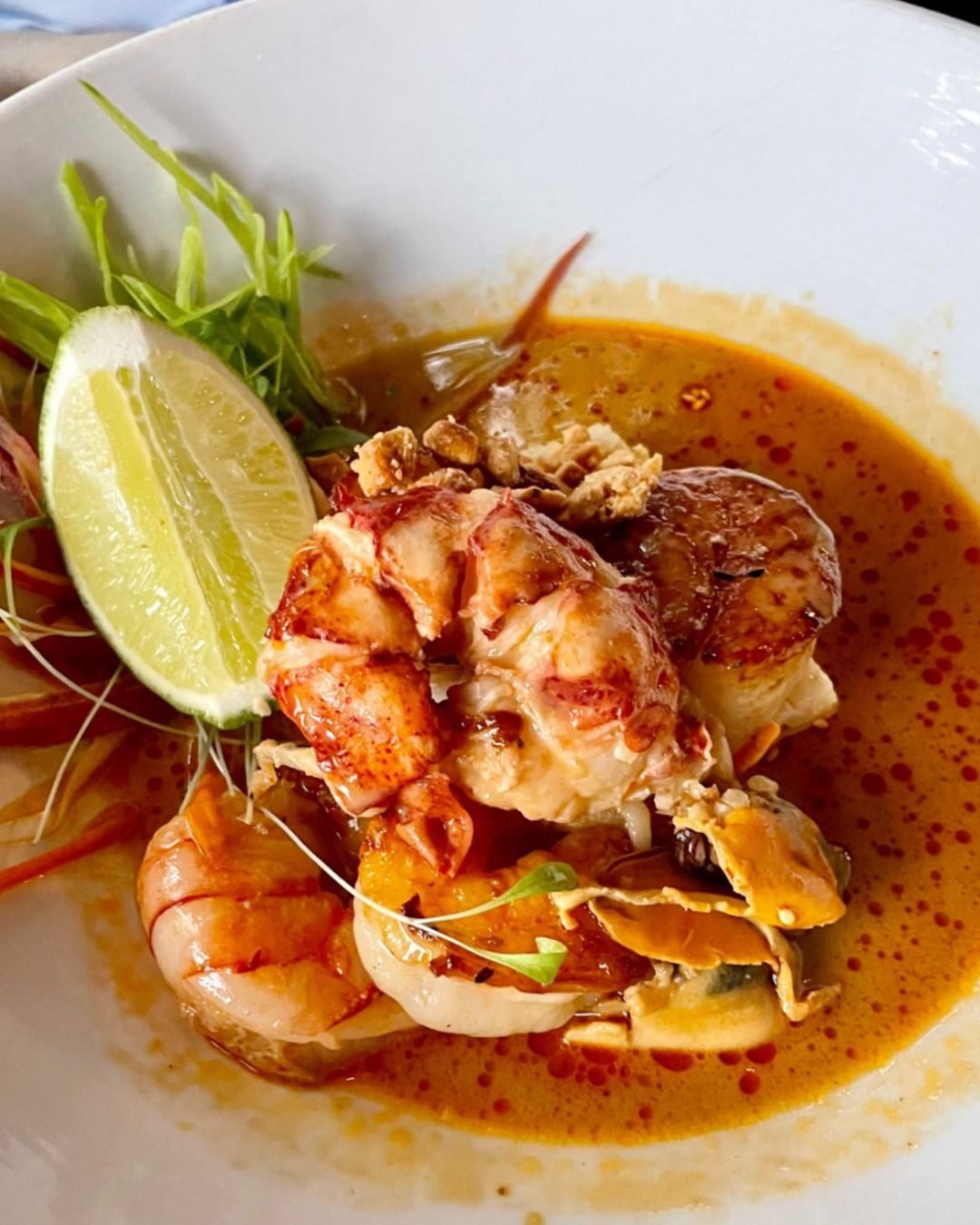 Sweet lobster, seared scallops, and shrimp layered over rice noodles in a fragrant Thai seafood broth. 🍜🦞

📸: @laursoriano