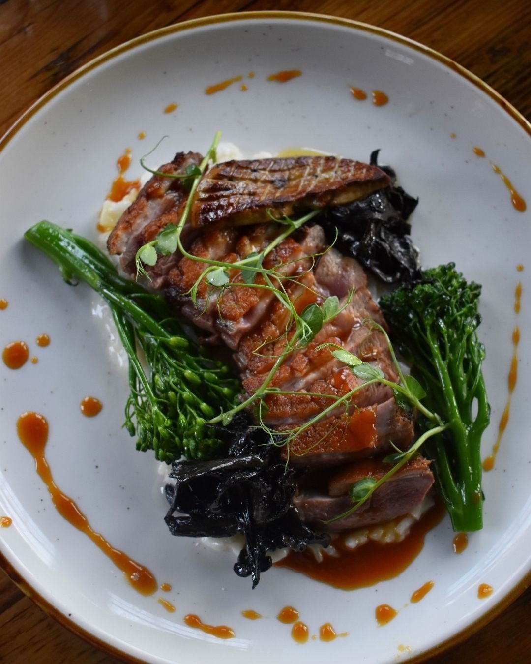 Rich, bold, and just a touch of bright. Muscovy Duck Breast with parsnip risotto, broccolini, black trumpets, foie gras, and blood orange gastrique. 🌿