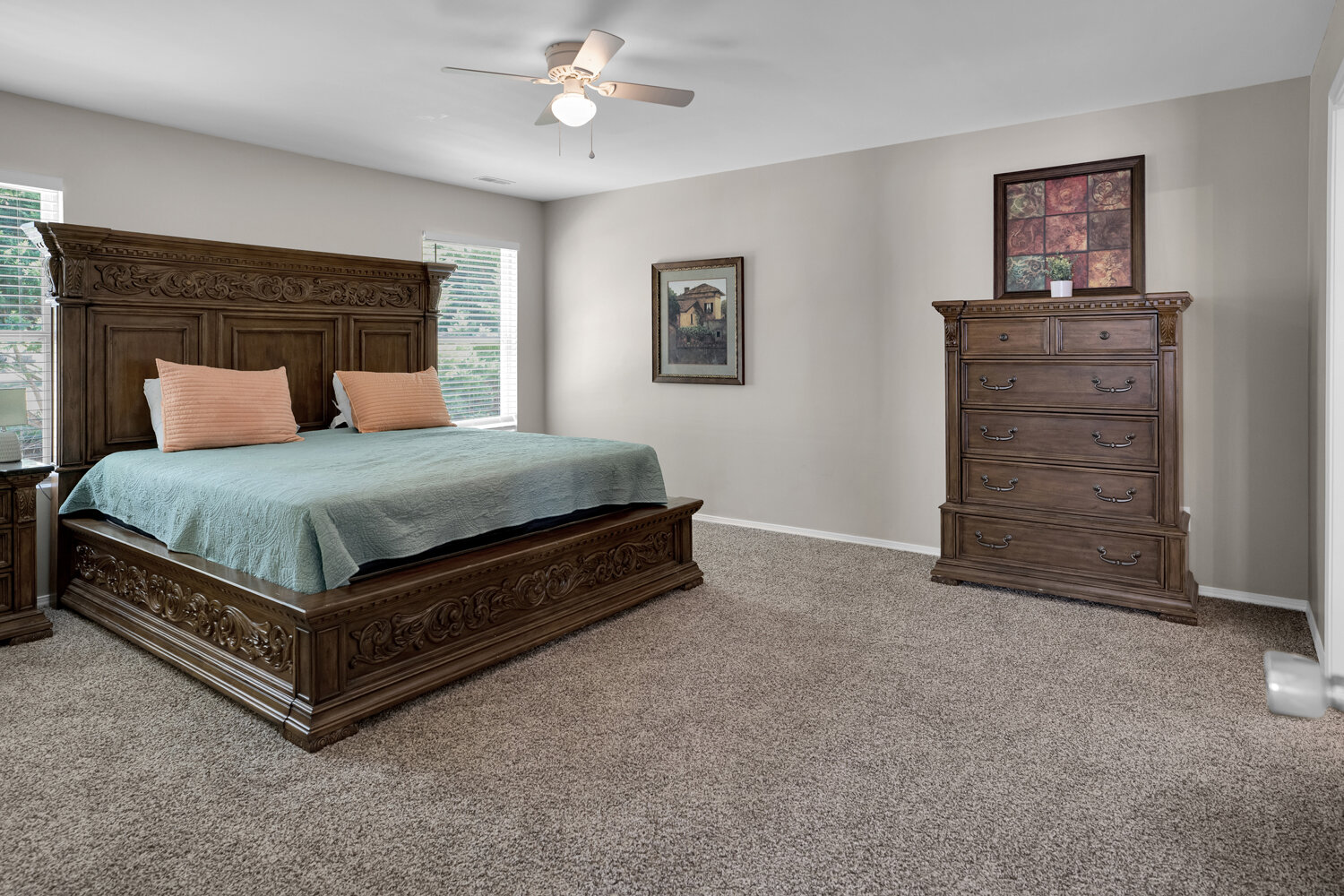 Owner's suite bedroom with windows on upper level
