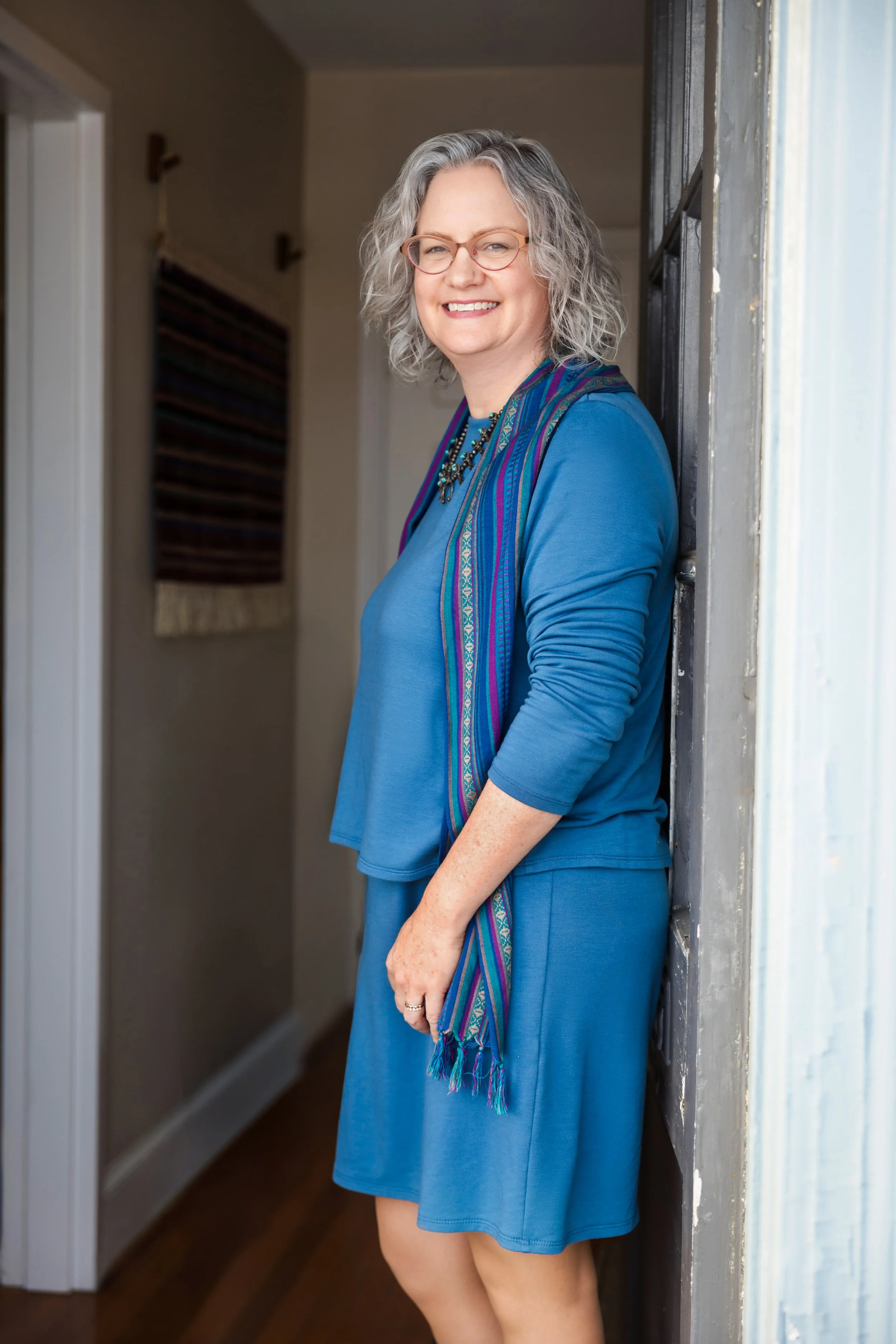 Hetty standing next to the door
