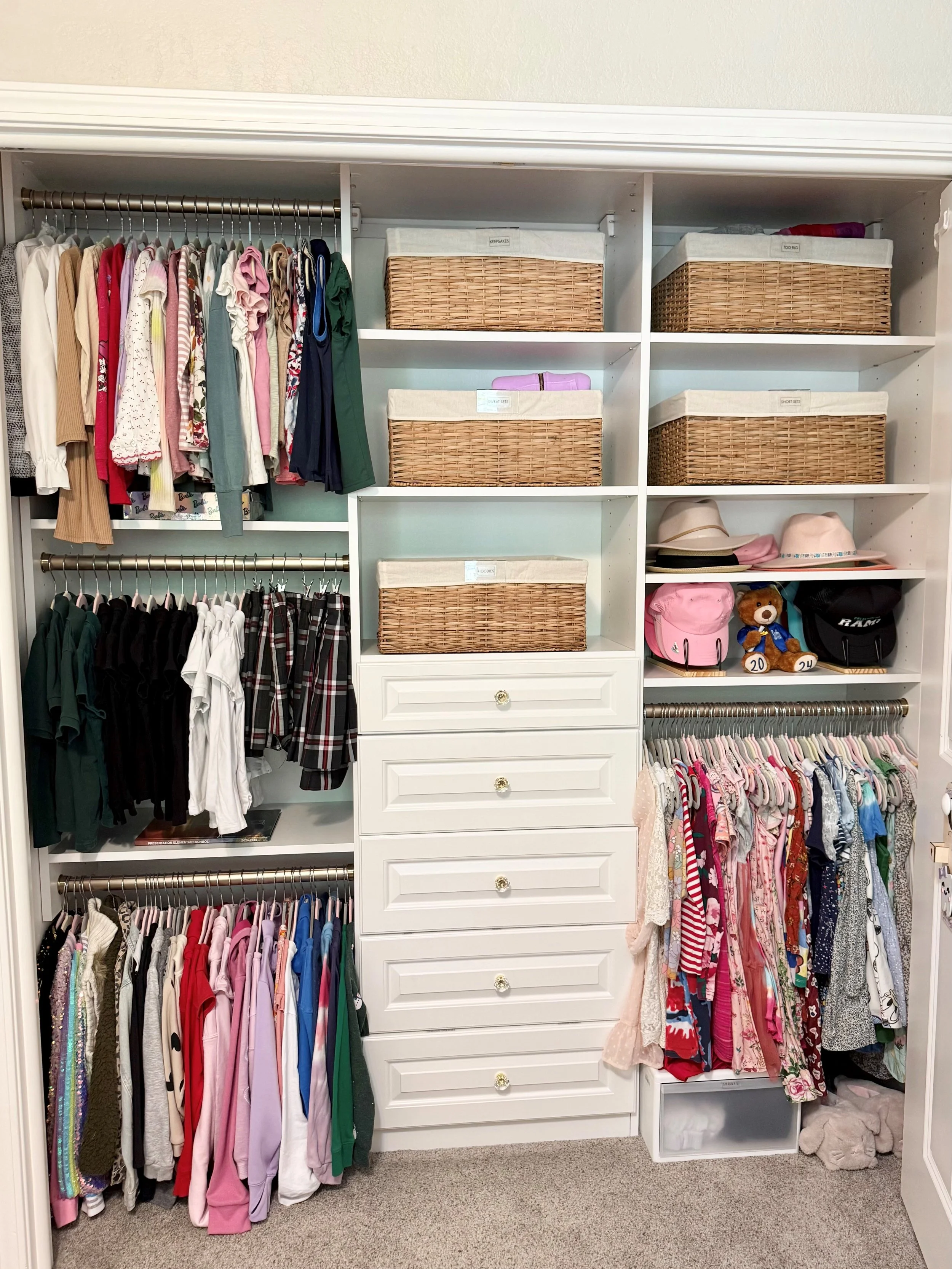 Organized kids closet with labeled baskets and clothing system by professional organizer in Stockton CA