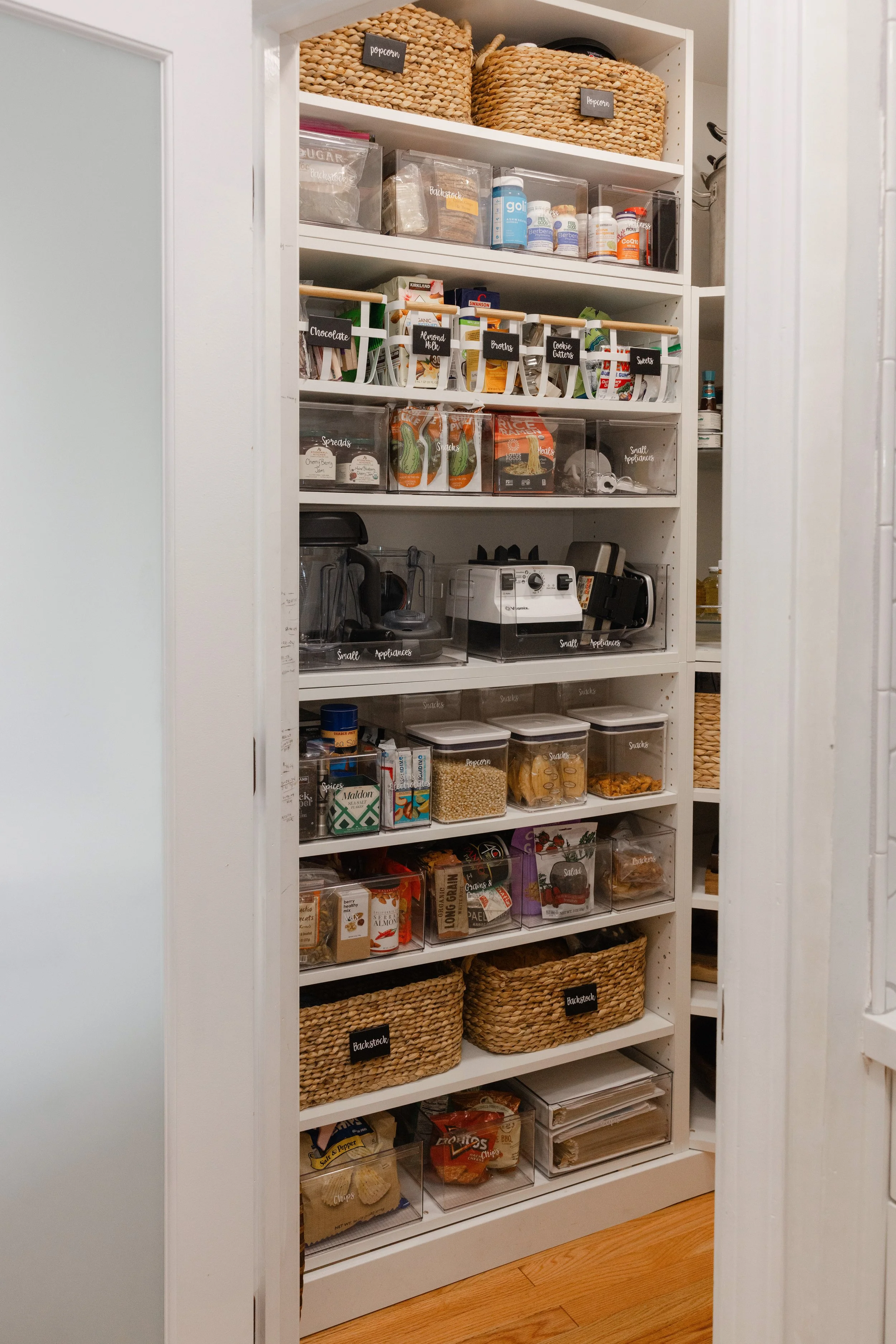 Organized pantry with clear labeled bins for holiday baking and everyday food storage