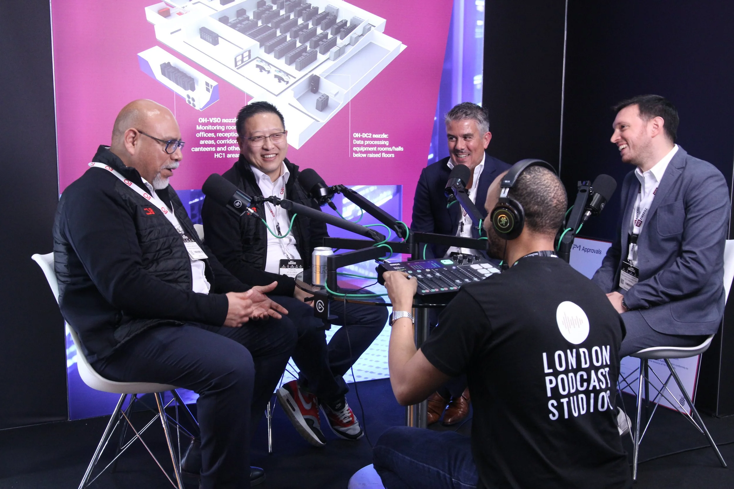 Audio engineer setting up podcast microphone on-location in London for a corporate video podcast service