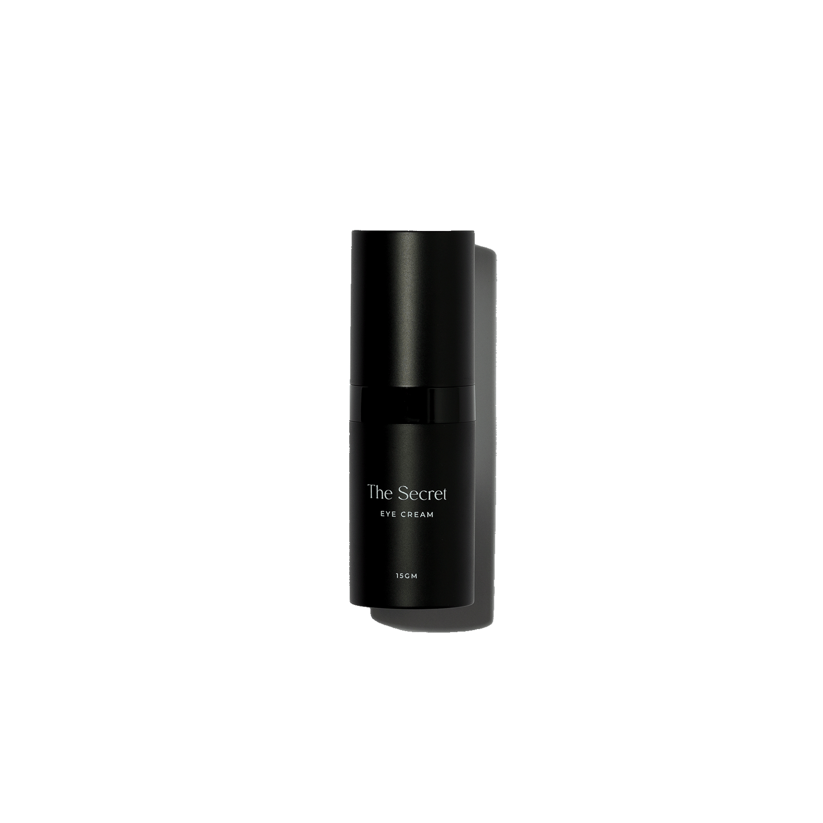 A black bottle of The Secret eye cream with silver accents, standing against a black background.