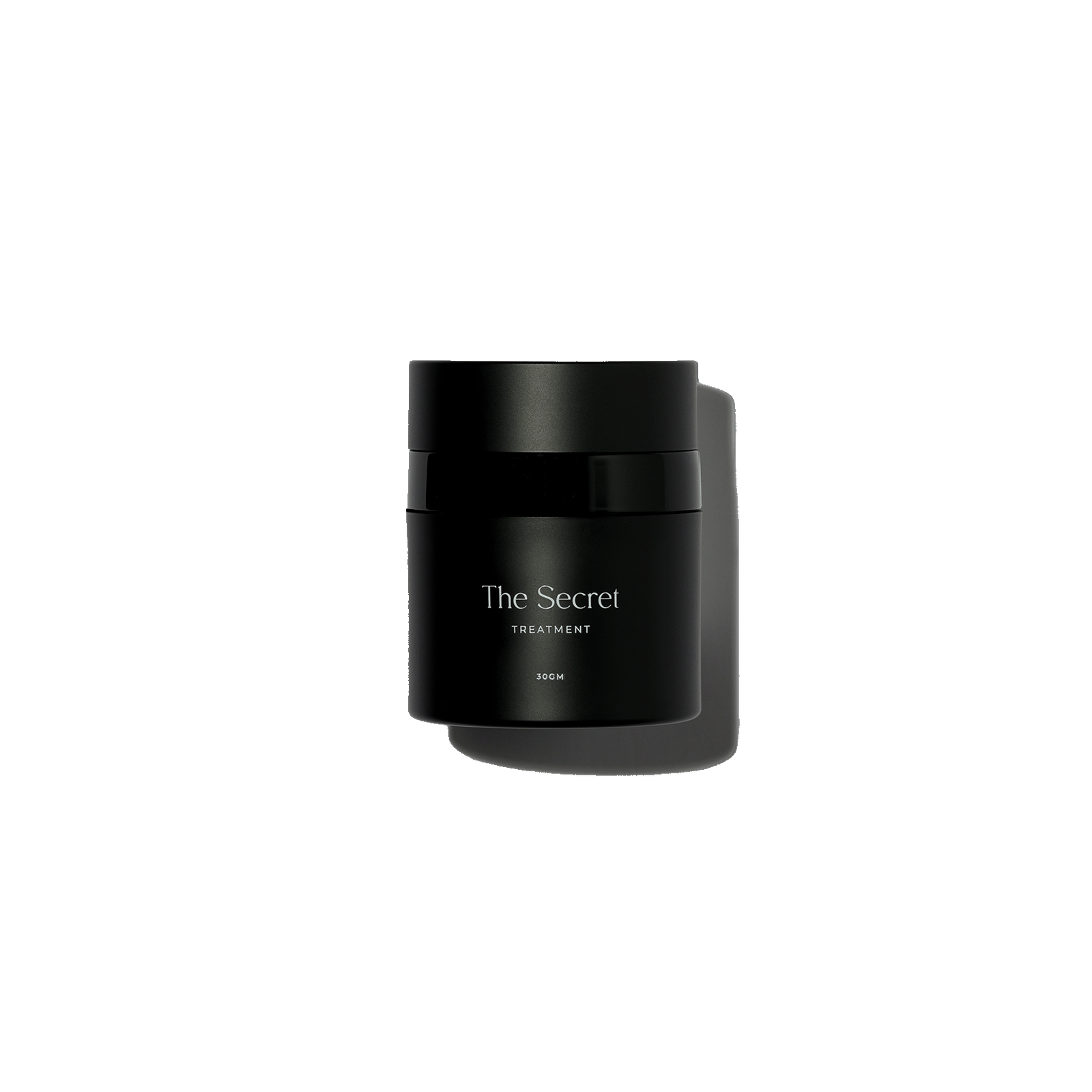 A black container with a label that reads "The Secret Treatment 30GM" against a black background.