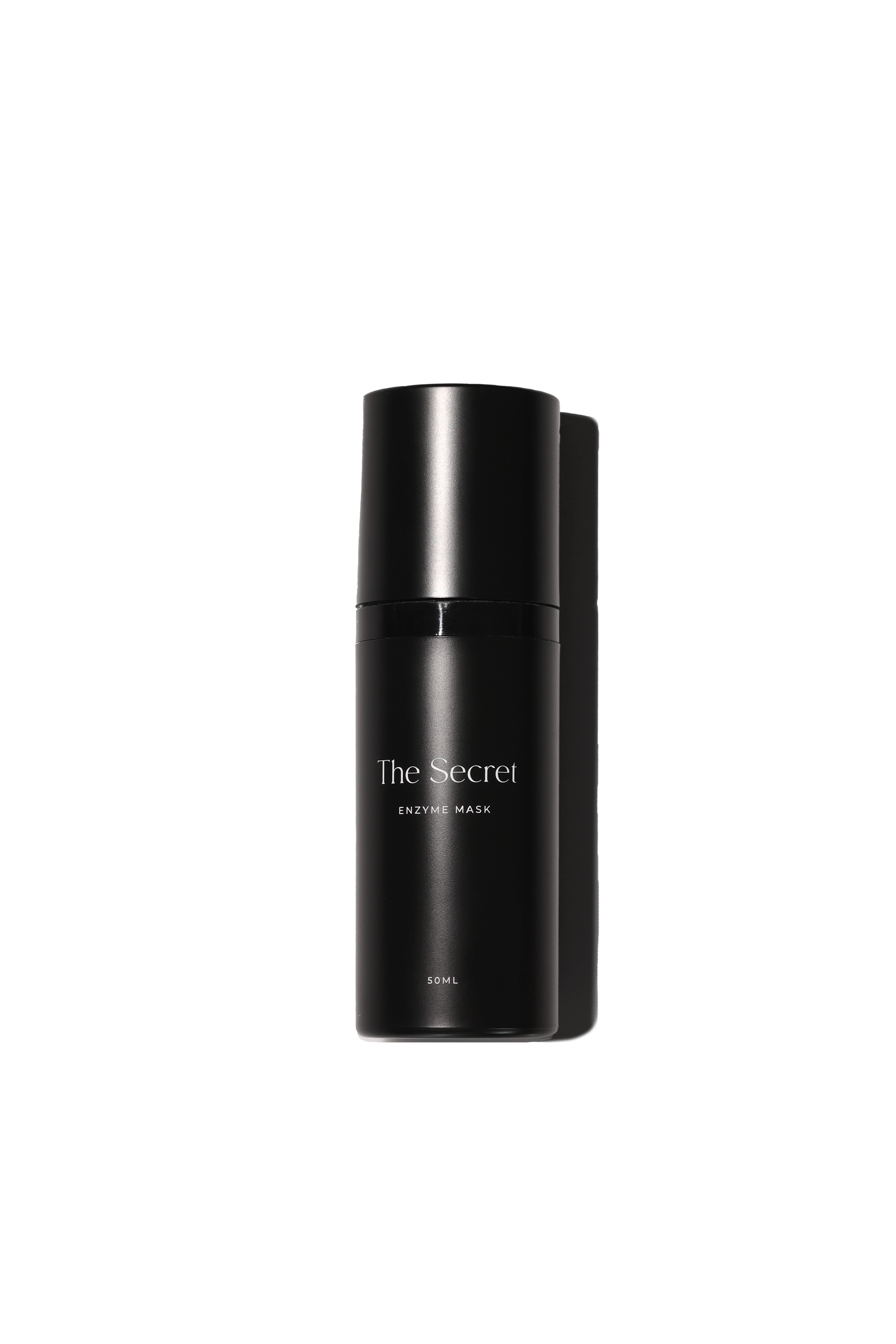 A black cylindrical bottle labeled 'The Secret Enzyme Mask 50ML' on a black background.