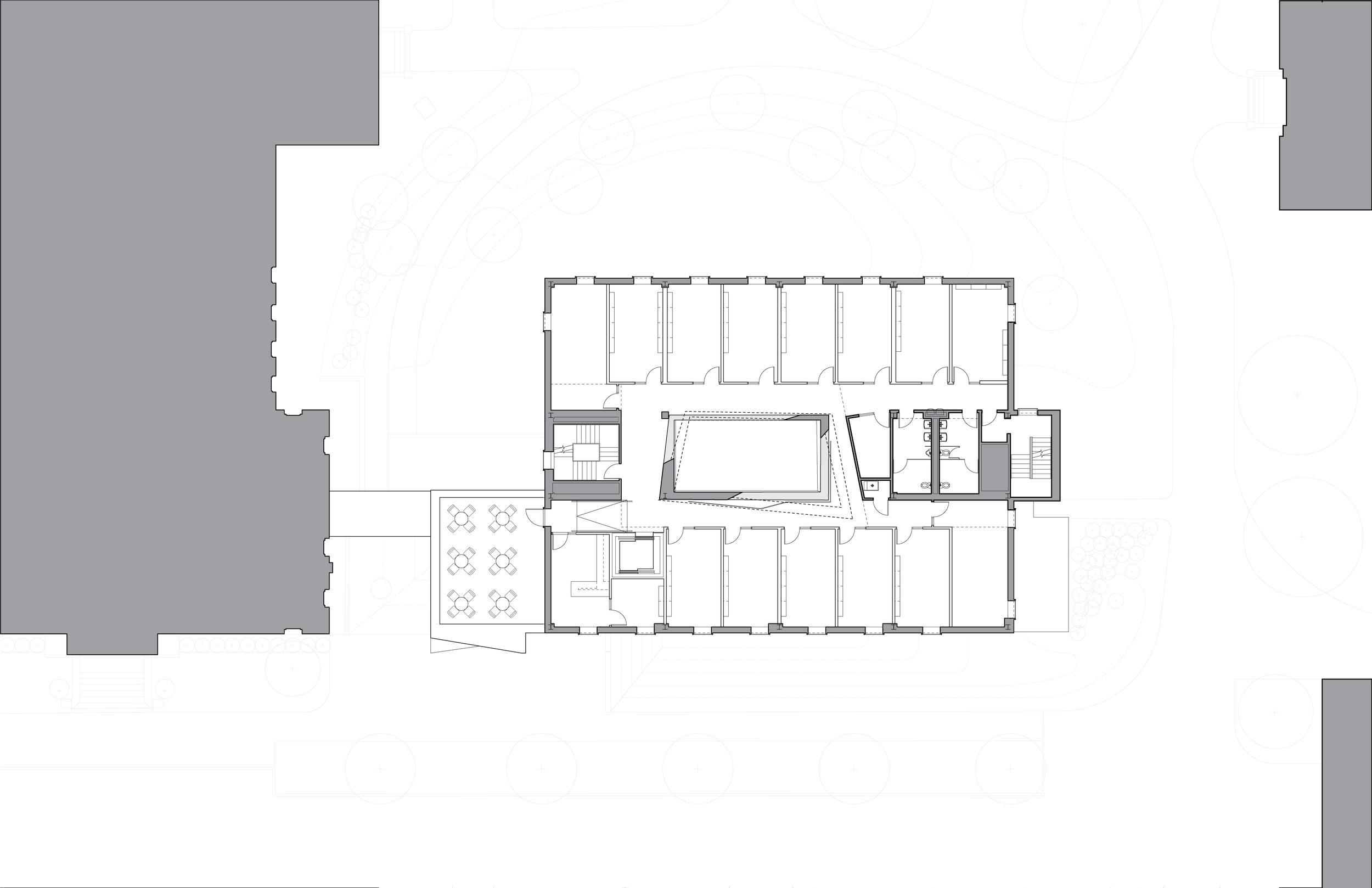 Architectural floor plan of a building, showing interior rooms, staircases, and outdoor seating area with tables.